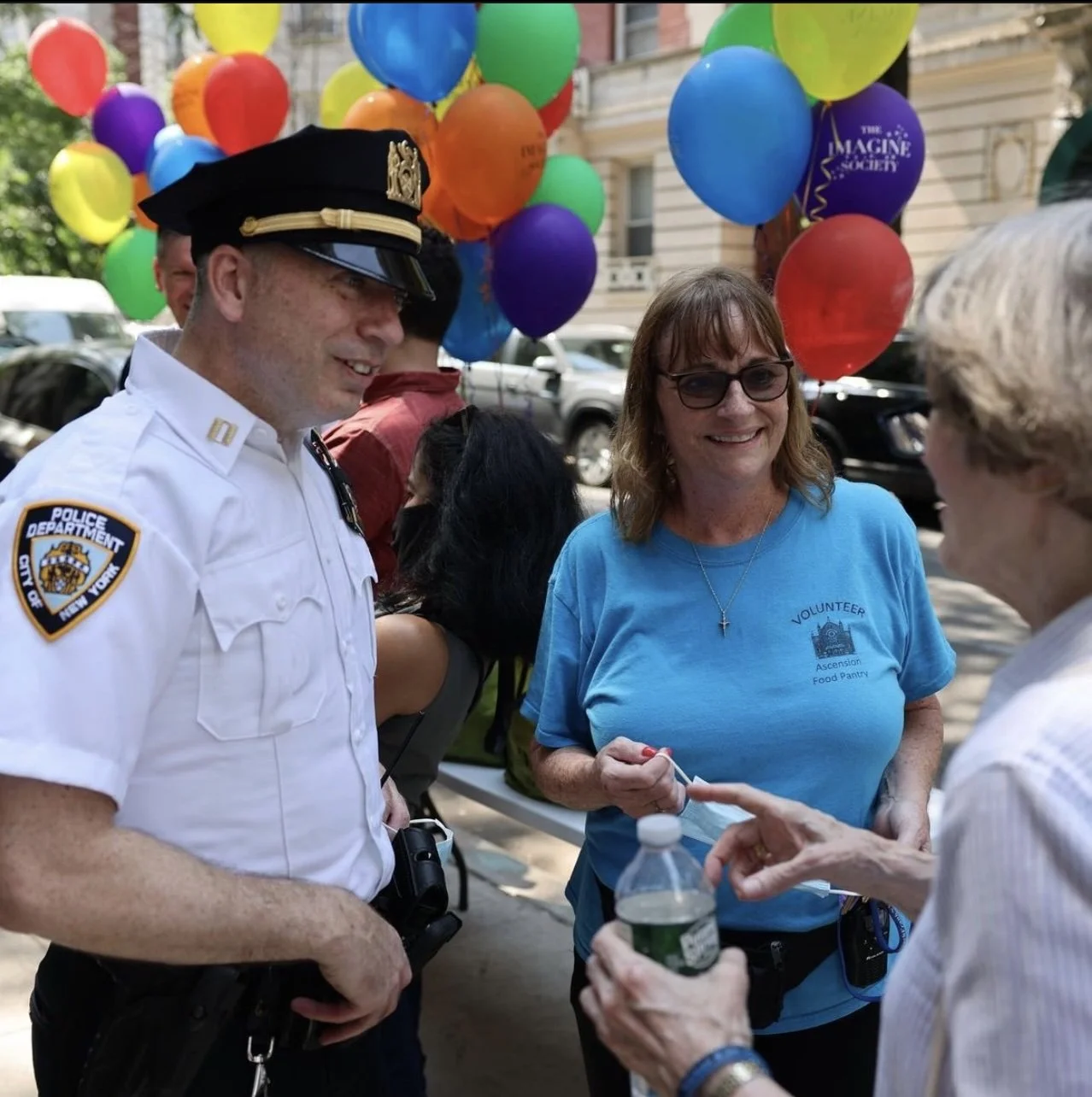 Pictured on the right is Robin, the director of the pantry, during a joint distribution with the NYPD.