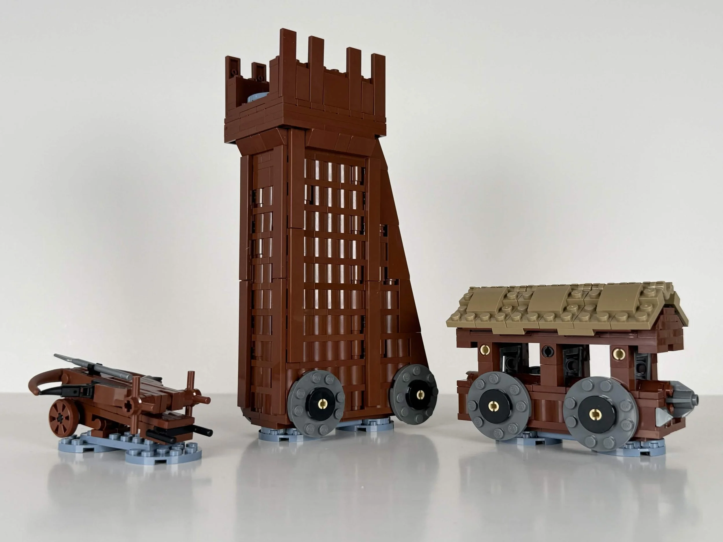 Left to Right: Ballista, Siege Tower, Battering Ram. The siege trifecta! Based on sand blue bases for use in a theoretical tabletop game.