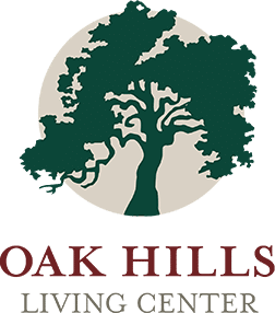 Meridian Healthcare Strategies partner's logo of Oak Hills Living Center with a large tree inside a circular shape, with the text 'OAK HILLS LIVING CENTER' below.