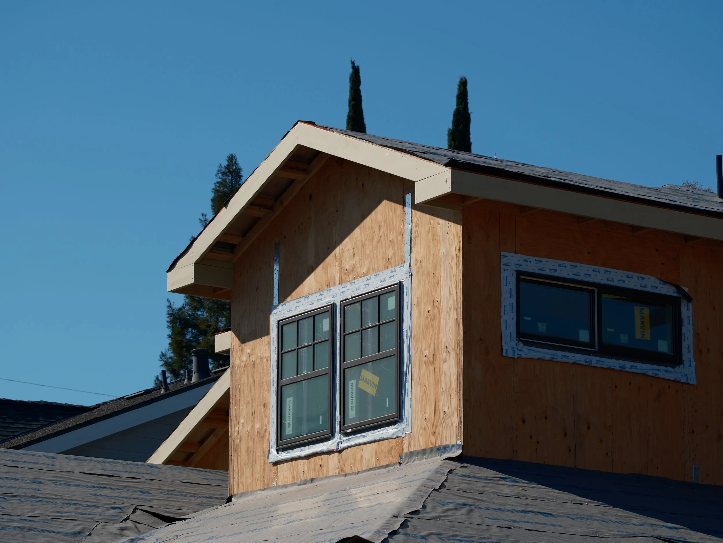 Oranssi technician working on a roof project
