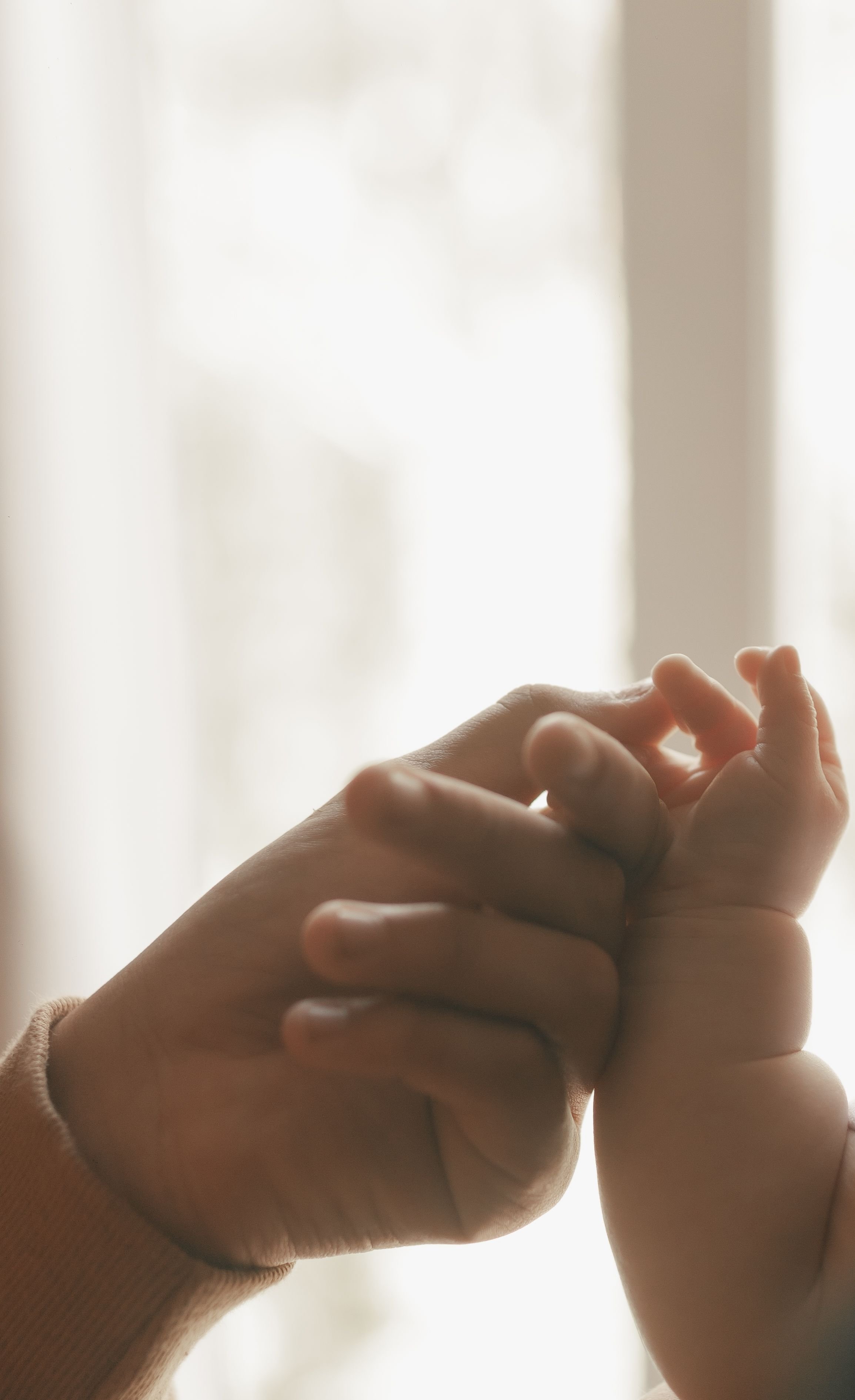 The mother-baby bond shown through a sweet hand touch
