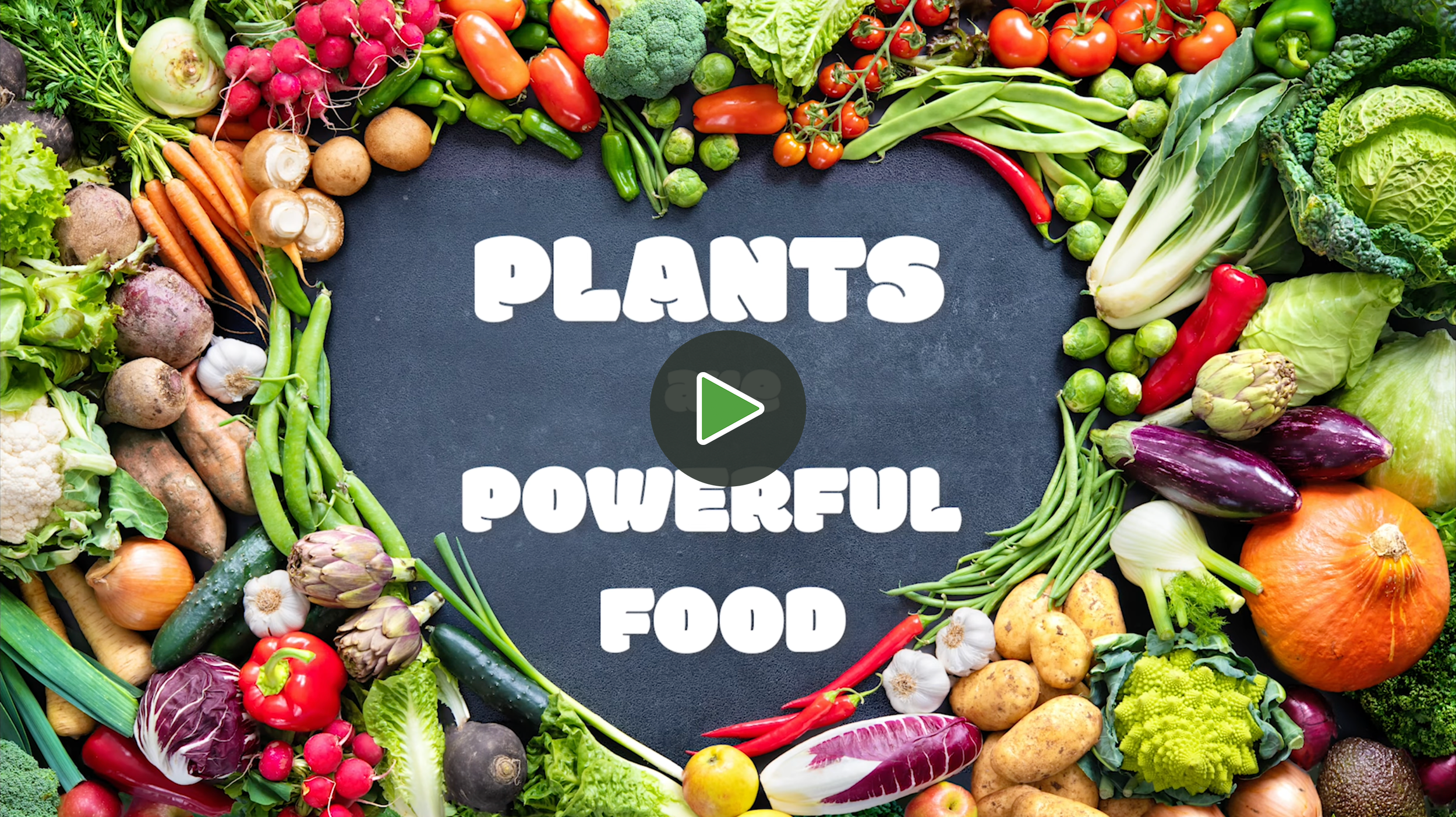 Colorful assortment of fresh vegetables arranged around a black chalkboard with the words 'Plants are Powerful Food' written on it.