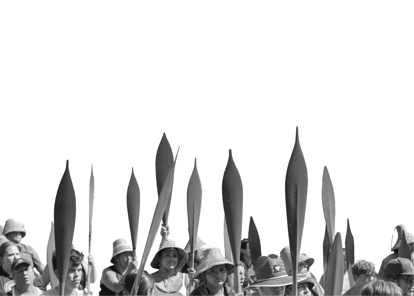 Black and white photo of a group of people with oars.