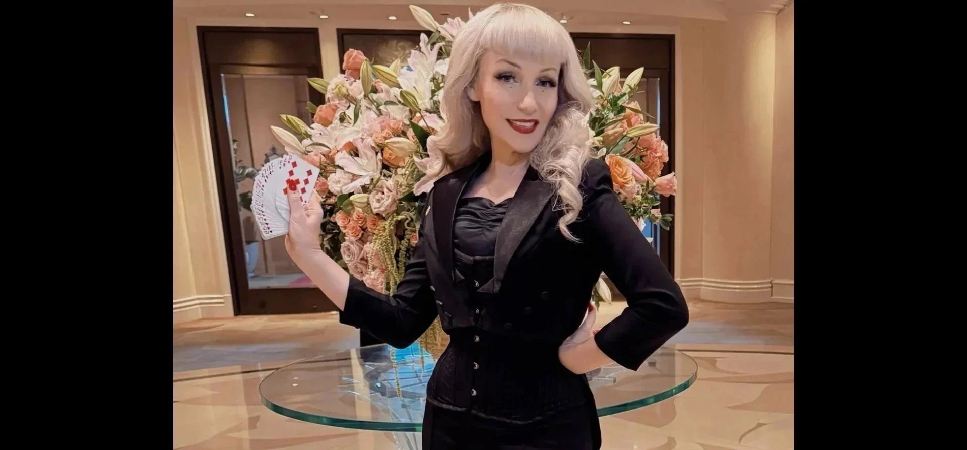 Female corporate magician Sansa Asylum performing strolling magic during a company reception in Los Angeles\.