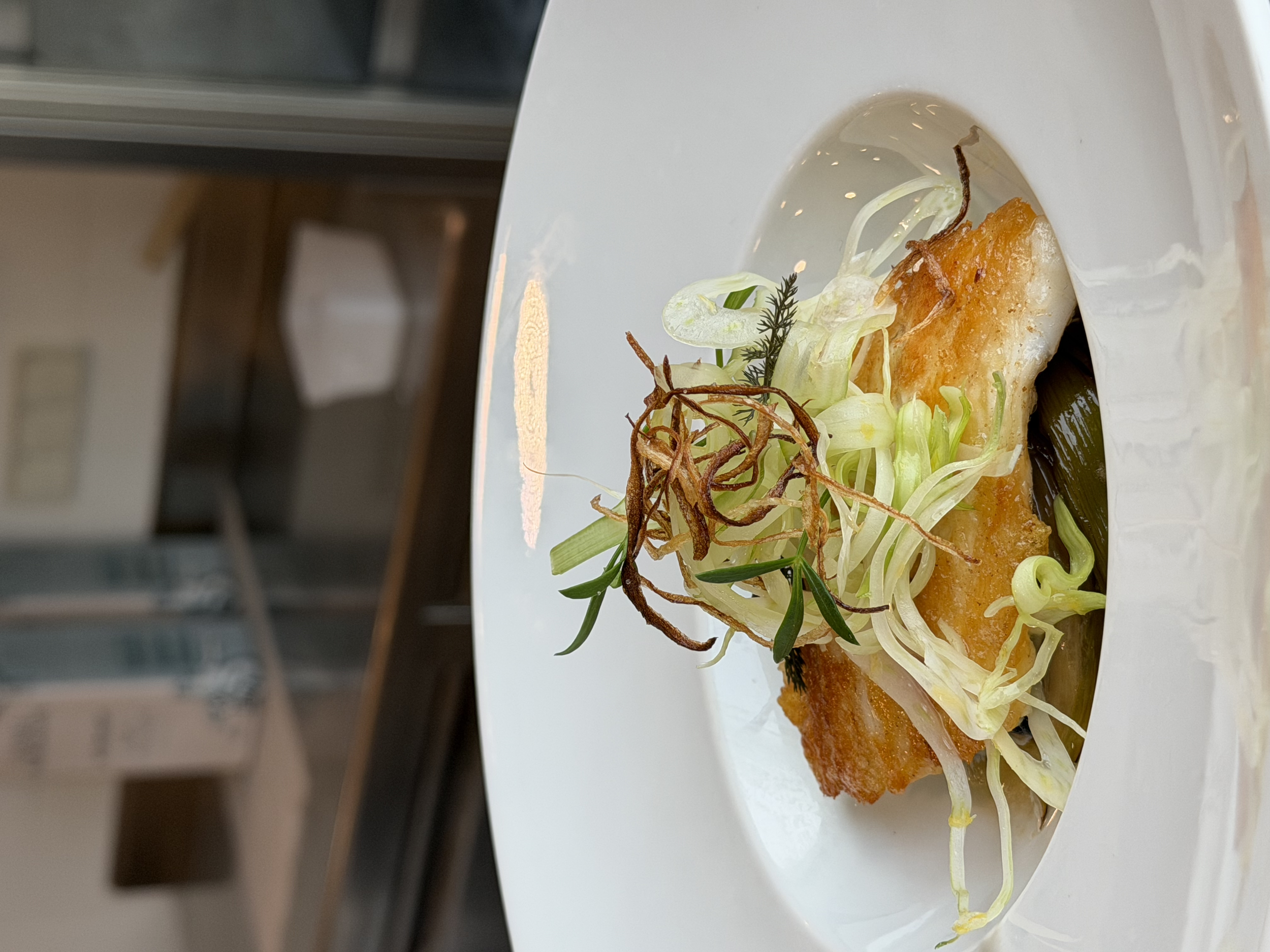 A composed fish dish with crisp vegetables