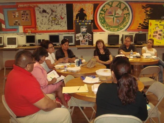 women around table at a group meeting