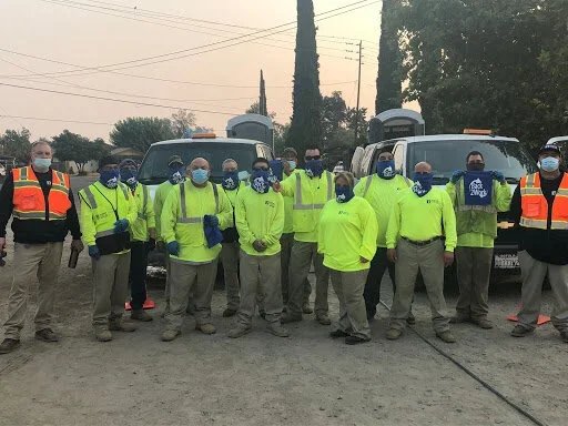 a group of men wearing masks and work clothes
