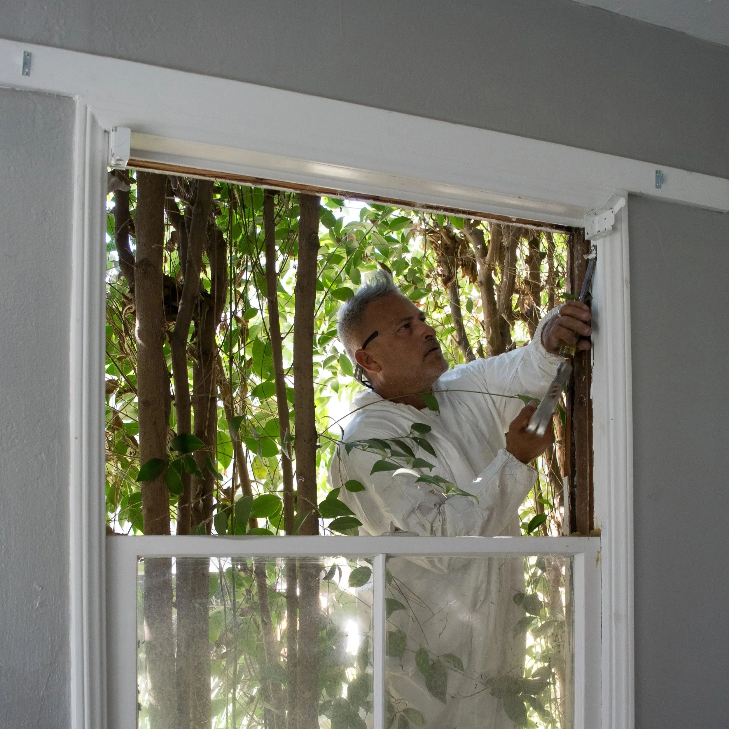 a man weatherizing a house