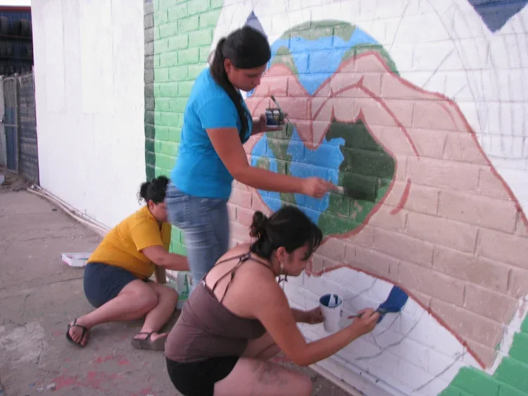 women painting a mural