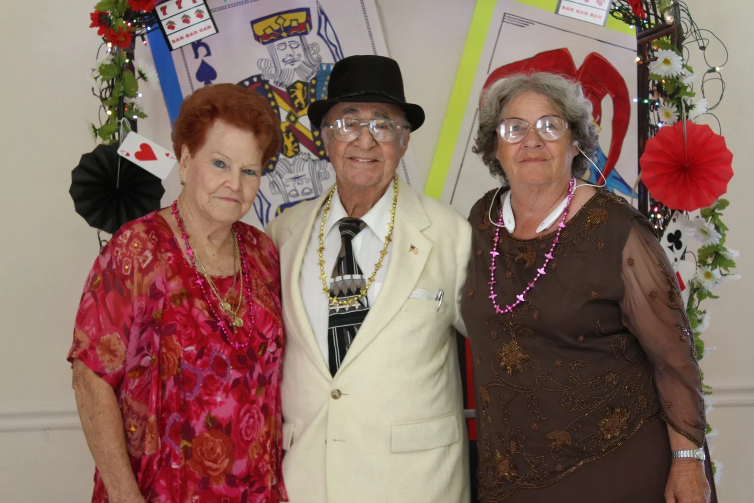 seniors dressed up for a dance in front of a Photo Booth