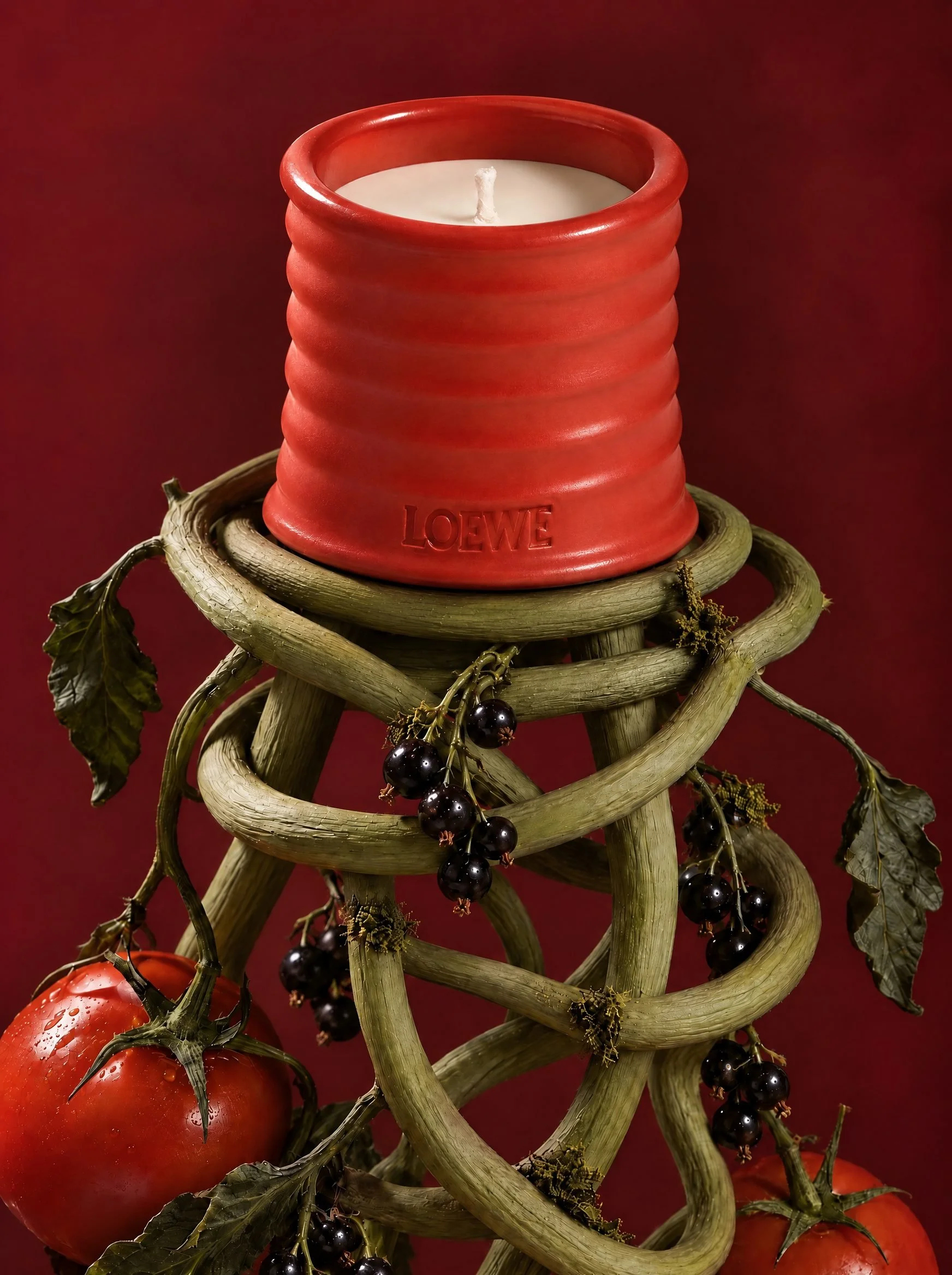 Candle on a sculptural knot of vines