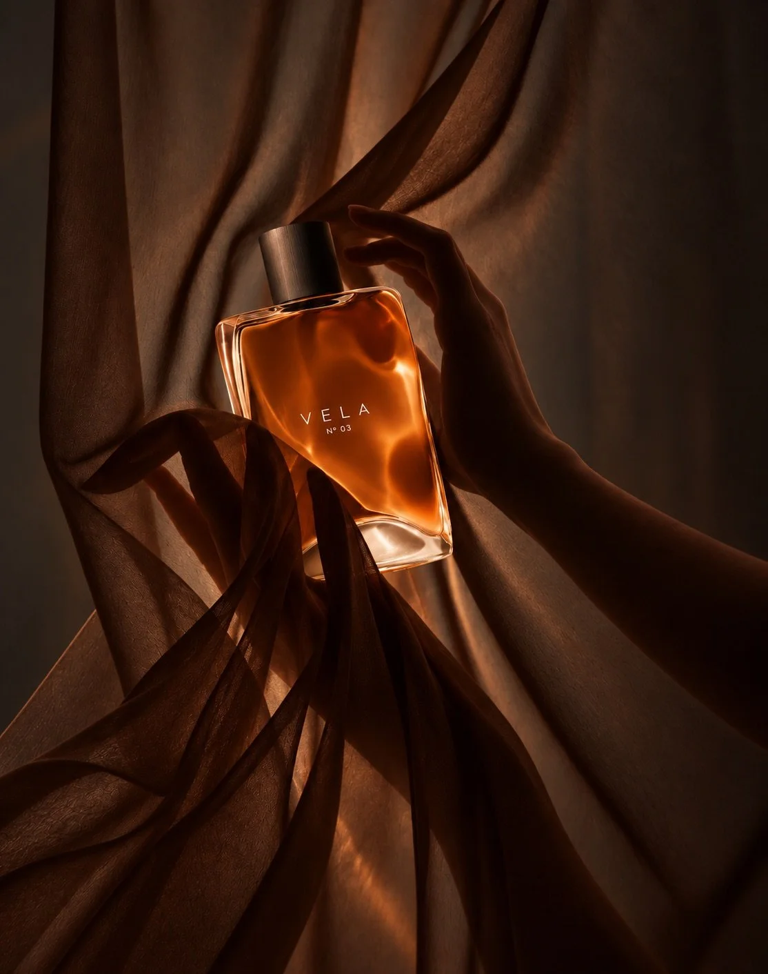 Hand holding the Vela bottle through sheer brown fabric