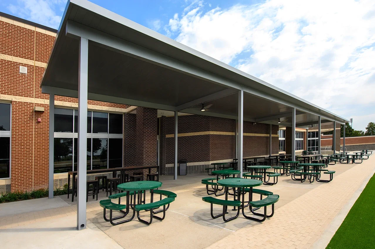 Synthetic turf and custom outdoor furniture added to Birdville High School courtyard under Friends Consulting Group oversight.