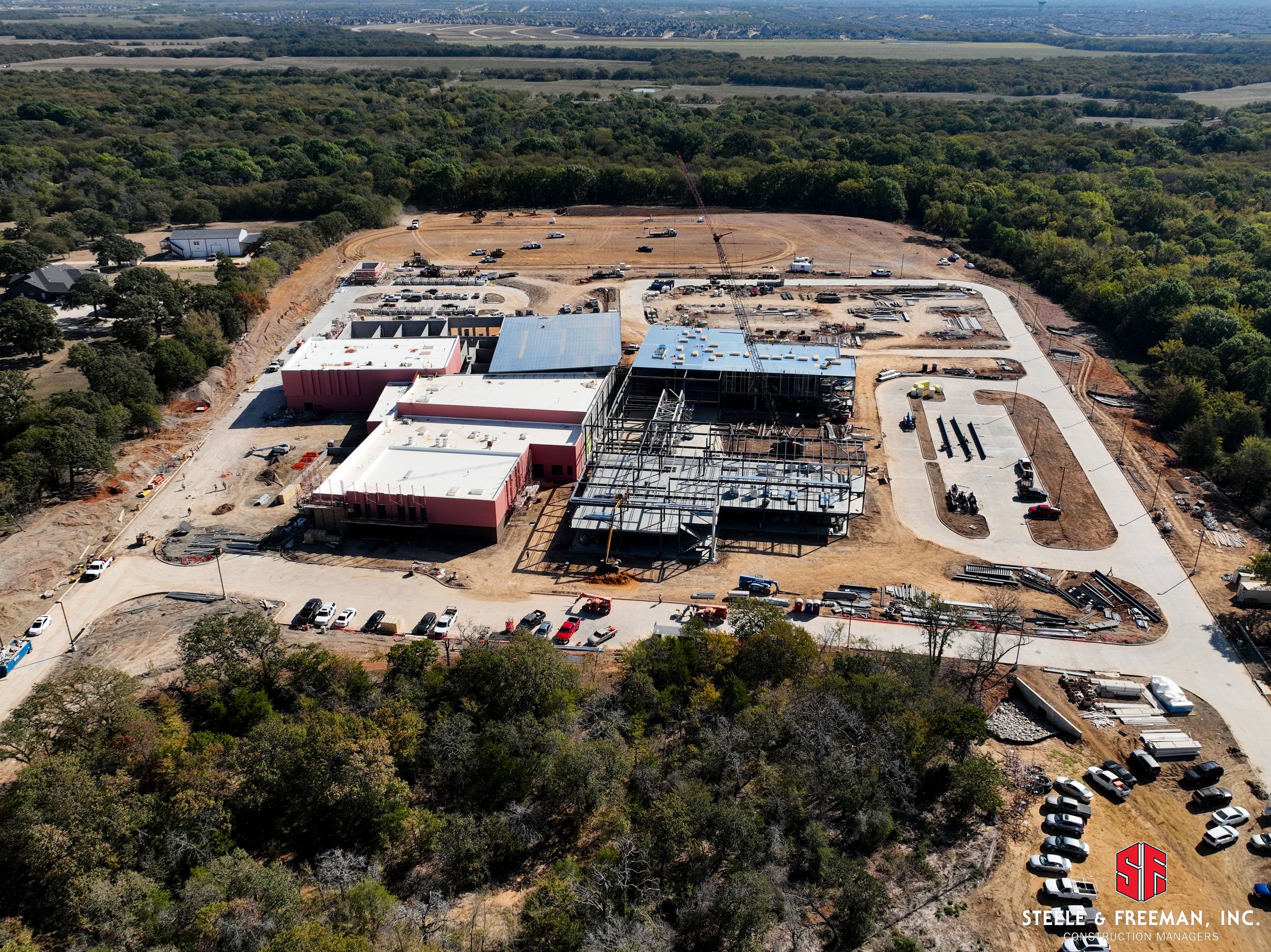 Roofing and exterior wall installation at Aubrey ISD middle school project.