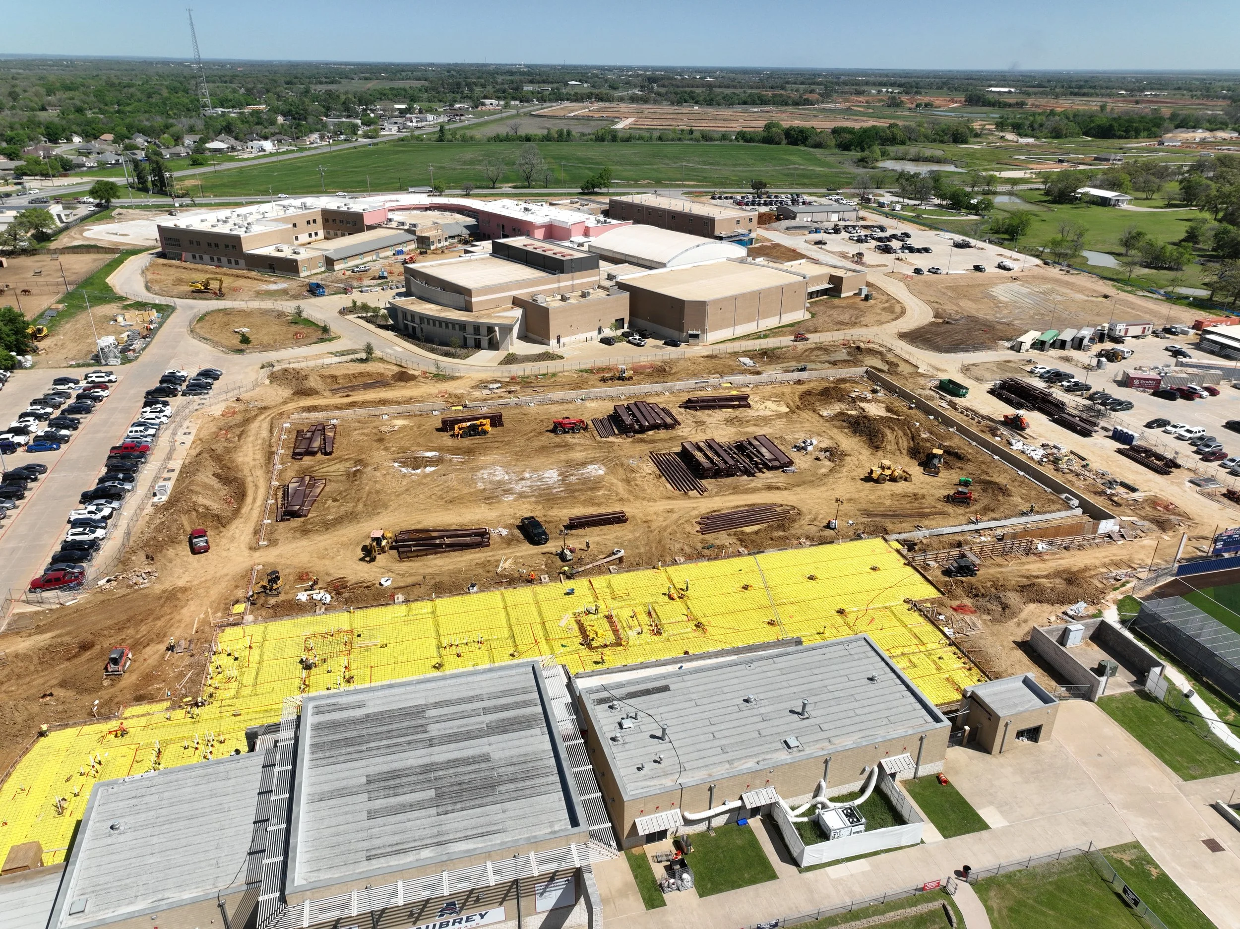 Active construction site at Aubrey High School expansion project scheduled for Summer 2026 completion.