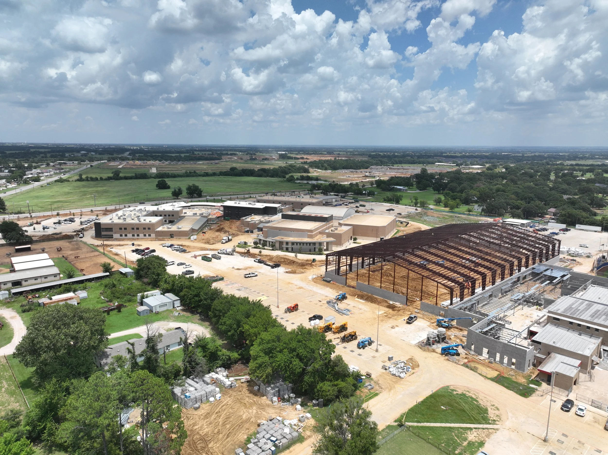 Steel framework installation at Aubrey ISD high school indoor practice facility.