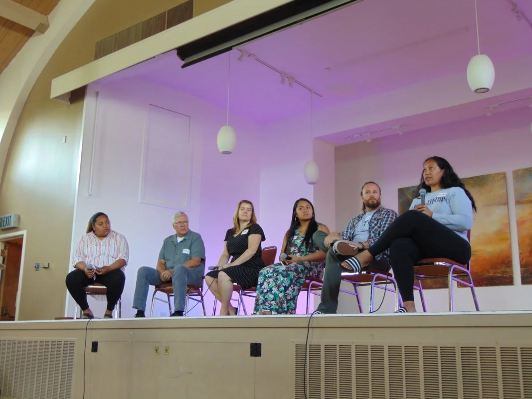 A panel of speakers from Lake B’s community answering questions from the stage in Fellowship Hall.