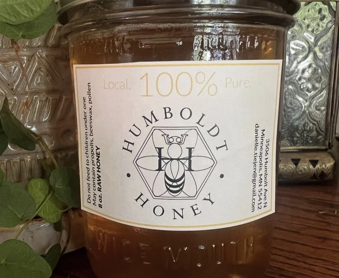 A jar of honey labeled 'Humboldt Honey', with a bee illustration, stating '100% local pure honey' and contact details on the side.