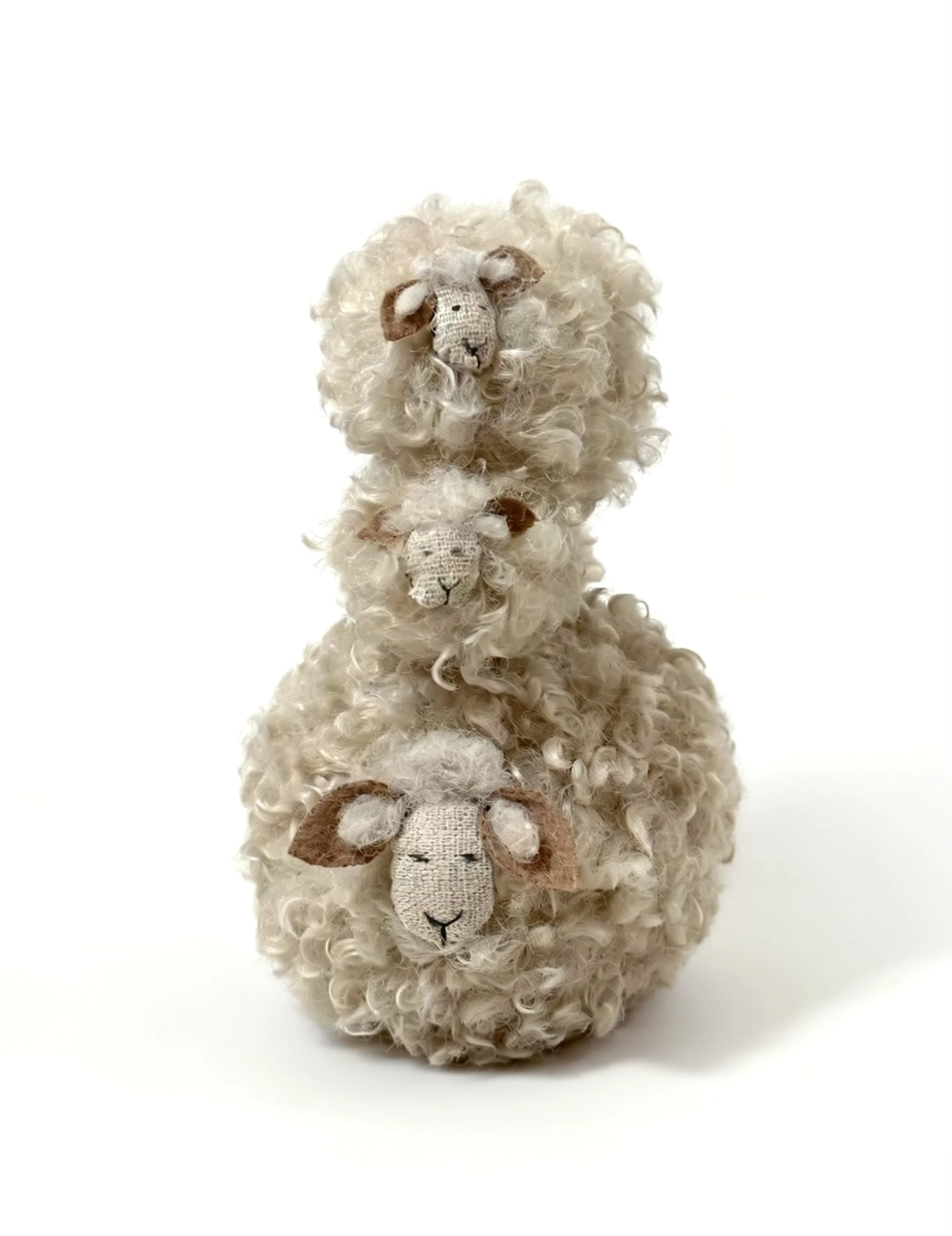 Three plush sheep with curly cream-colored fur and embroidered faces, stacked vertically on a white background.