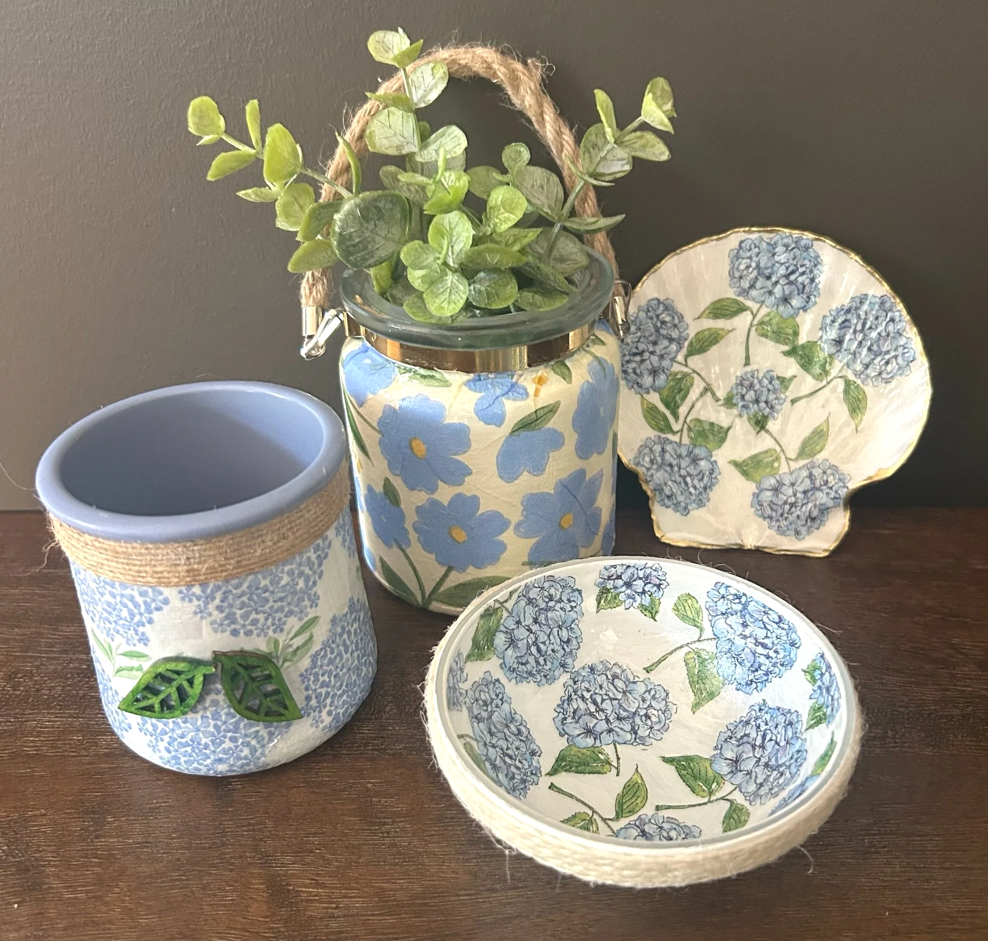 Decorative ceramic dishes and jars with blue floral patterns on a dark wooden surface.