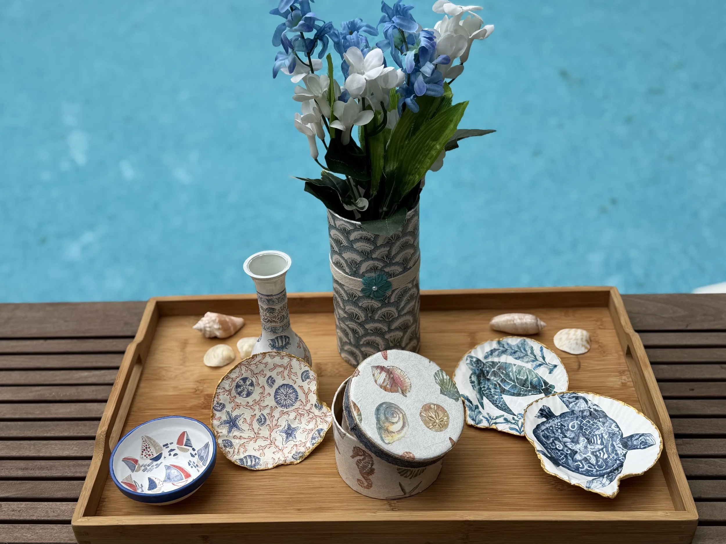 A variety of coastal themed items including bowls, shells, vases and a box for collecting your personal shells.  