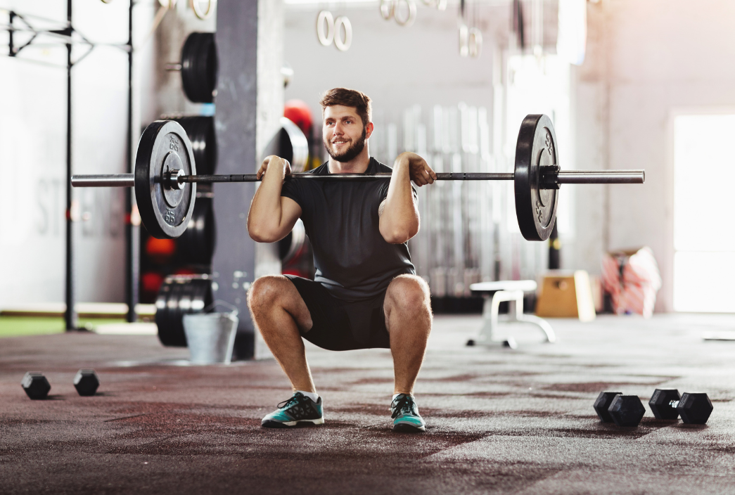 Male front squatting a barbell