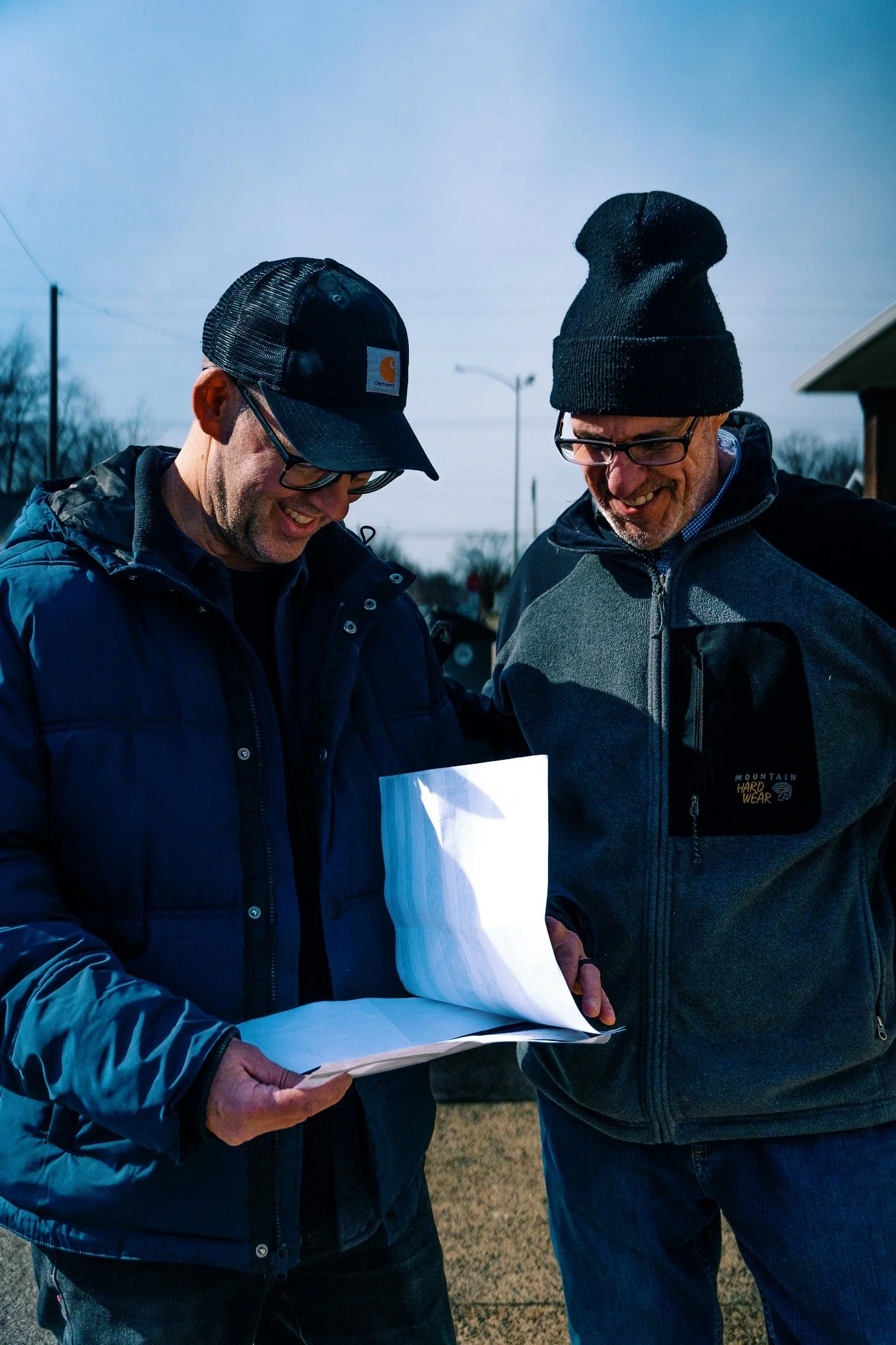 Chris Weatherly and David Ross reviewing video production schedule for short film project.