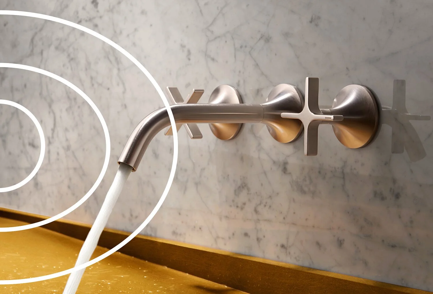 A modern stainless steel faucet mounted on a marble wall, with water flowing into a yellow sink below.
