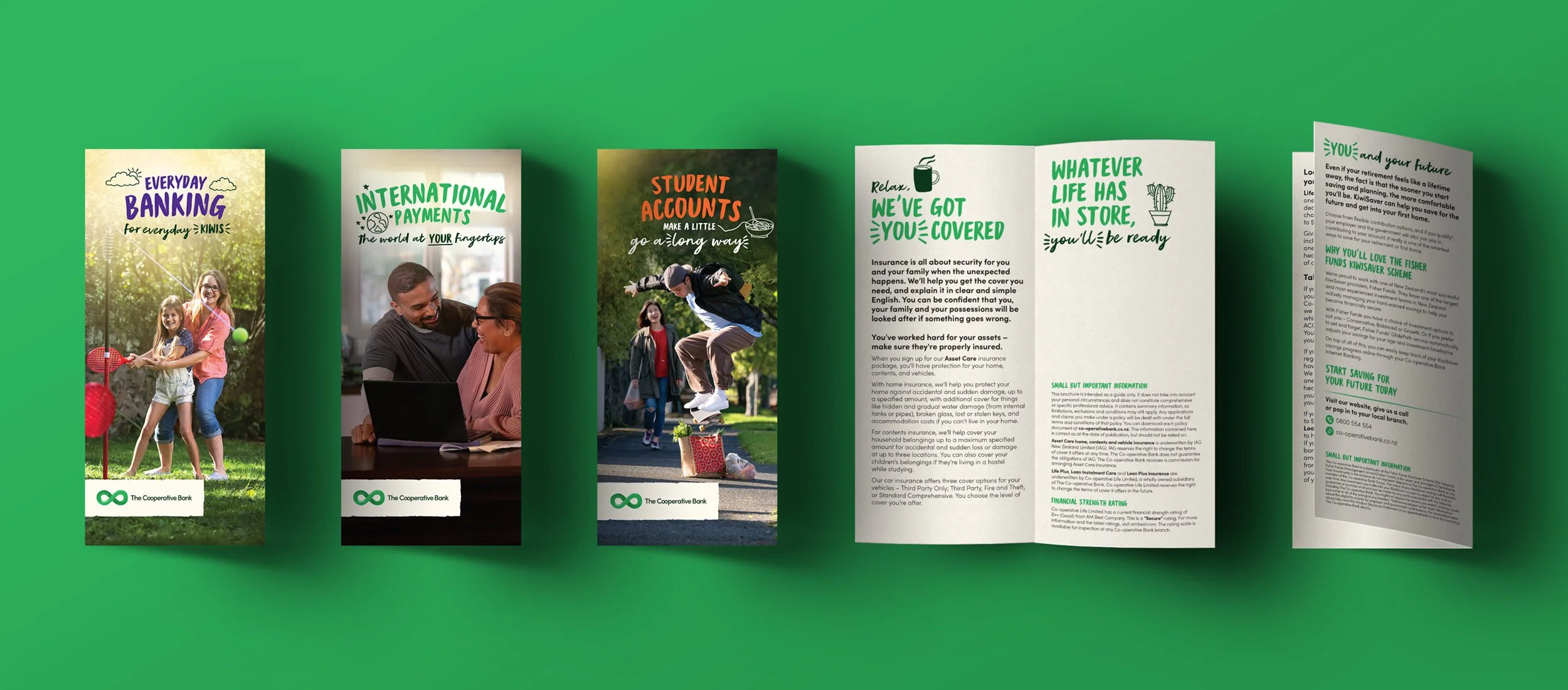 A set of pamphlets and brochures from The Cooperative Bank displayed on a green background. The first pamphlet shows two children playing badminton outdoors. The second pamphlet features two people in a home setting, smiling at a laptop. The third pamphlet depicts a person jumping over a shopping bag in a park. The fourth pamphlet contains information about insurance coverage with a coffee mug illustration, and the fifth pamphlet discusses KiwiSaver schemes with detailed text.