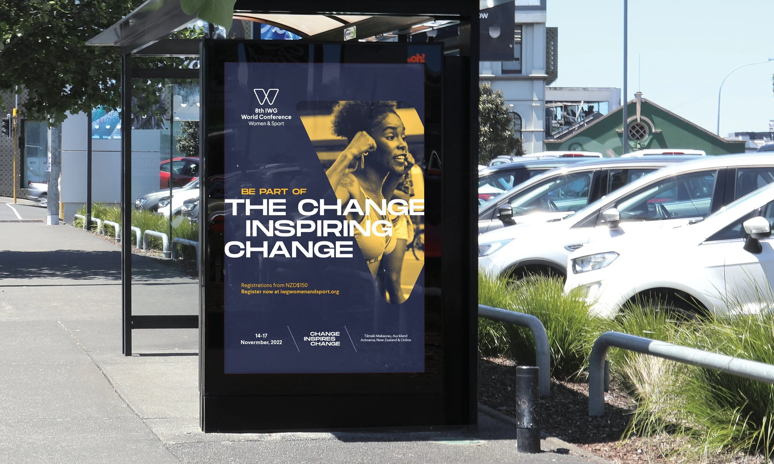 Poster advertising the 8th IWG World Conference on Women & Sport, held in Auckland, New Zealand, in November 2022. The poster features a woman flexing her arm and smiling, with the text 'Be Part of the Change Inspiring Change' and registration details.