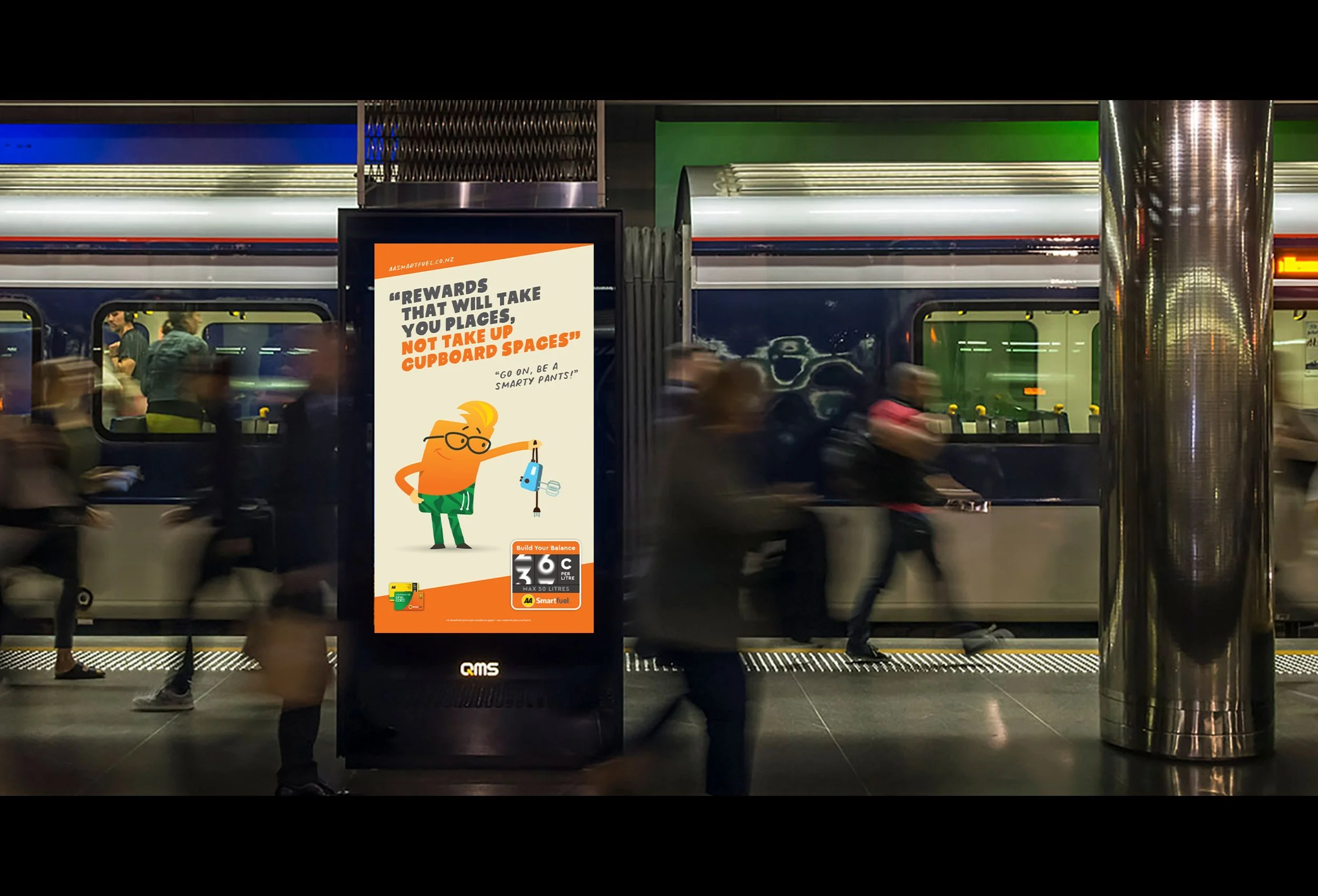 People walking past a digital billboard at a train station. The billboard displays a message about rewards and cupboard spaces, with an illustration of a cartoon character wearing glasses and holding a device.
