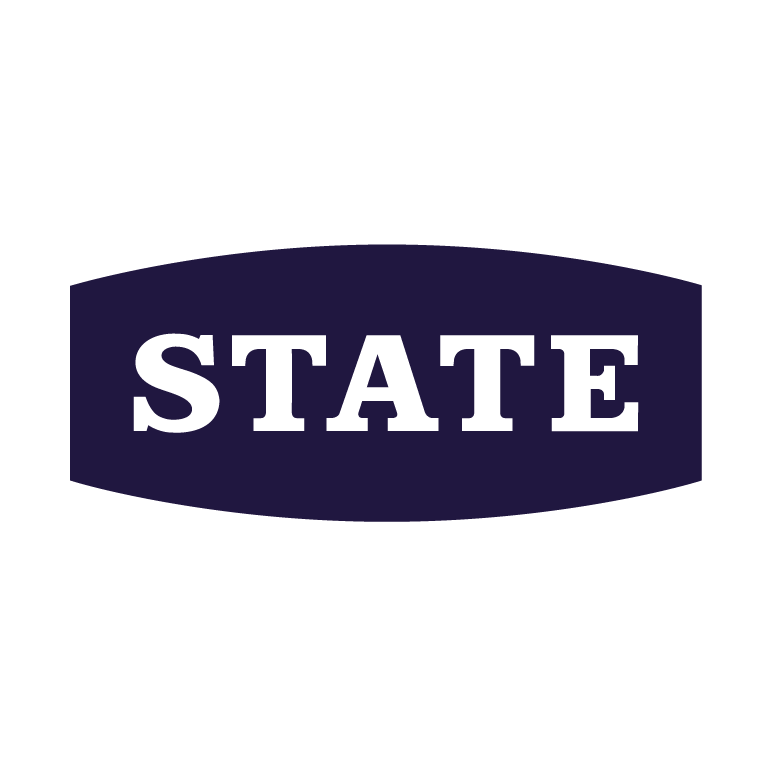 Close-up of a black sticker with the word 'STATE' in bold black letters on a dark background.