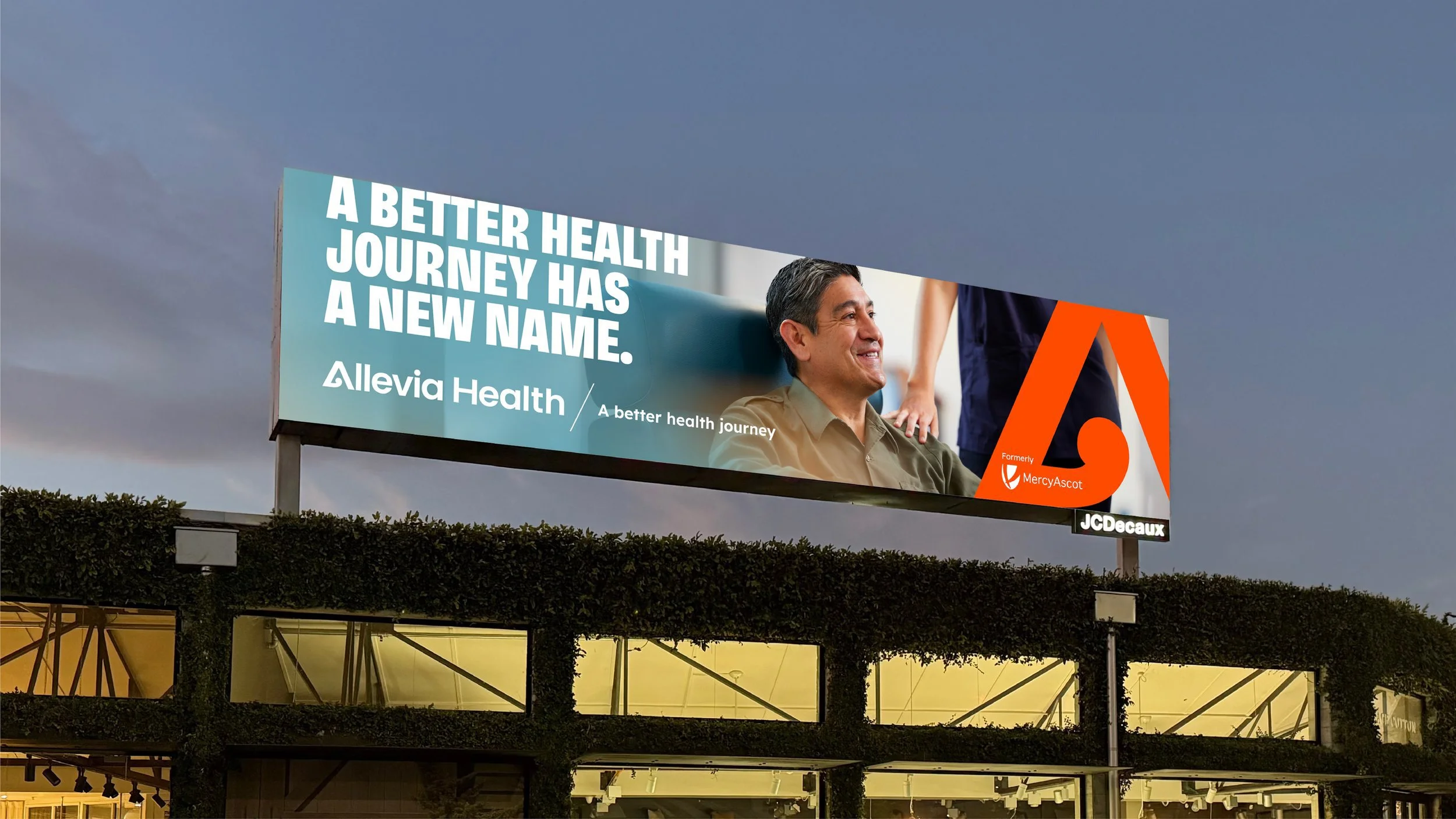 Billboard promoting Allevia Health, formerly MercyAscot, with a smiling man and healthcare staff in the background, and the JC Decaux logo at the bottom.