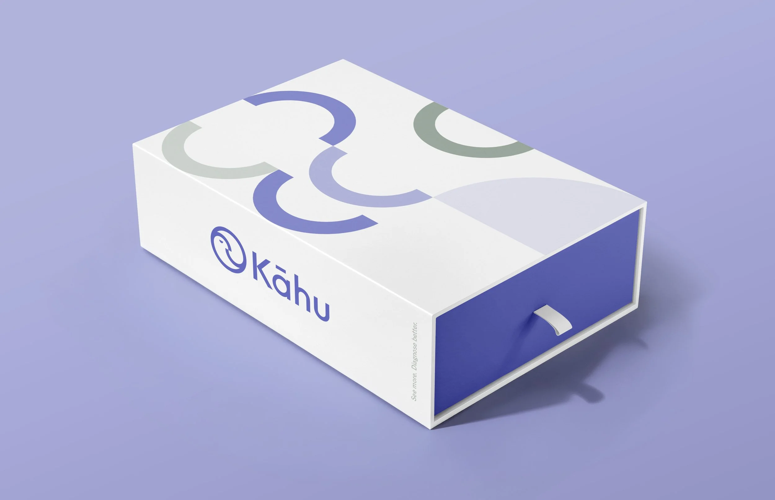 A white and blue box with the logo and text 'kāhu' on the side. The box features a minimalist design with abstract circular patterns in shades of purple and gray. The background is a solid light purple color.