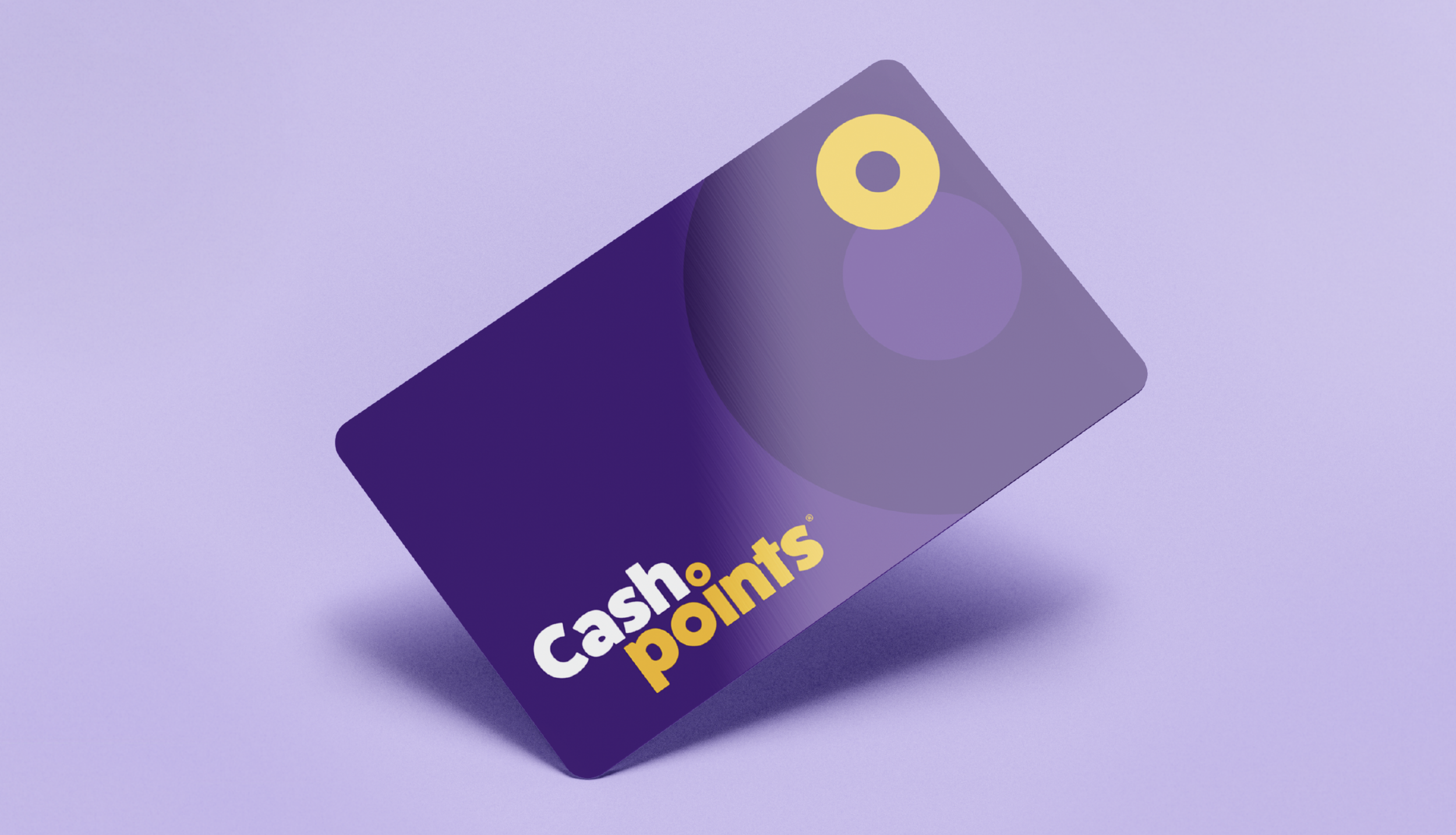 Close-up of a purple box of cashew points snack with yellow and white text, placed on a purple surface.