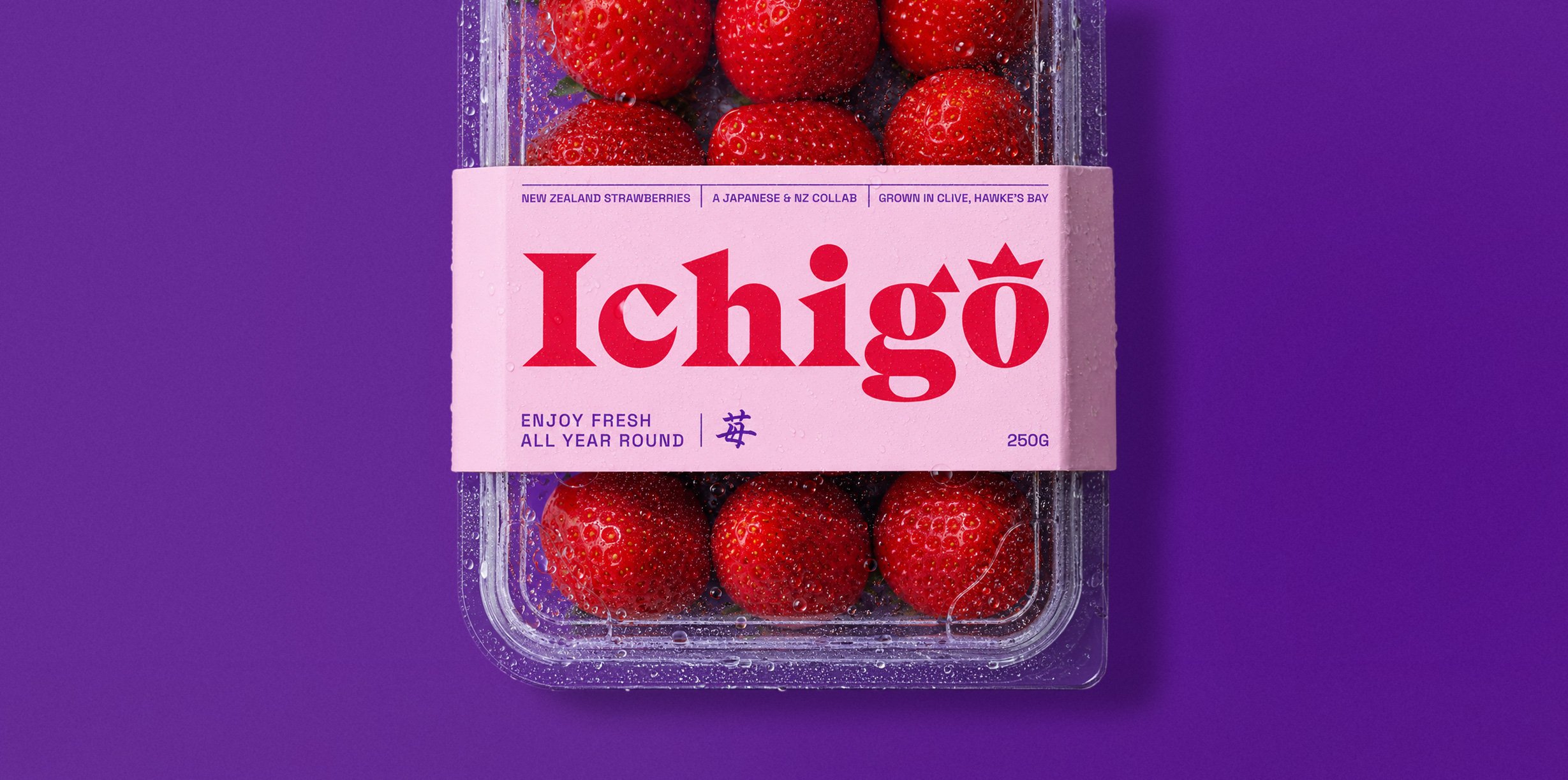 Container of fresh strawberries with a pink label reading 'Ichigo' and additional text, set against a purple background.