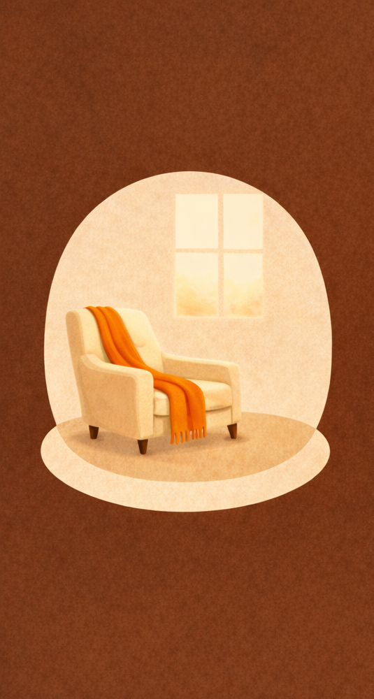 A cozy indoor scene of an armchair with an orange throw blanket draped over it, set on a round white rug near a window with sunlight streaming in.