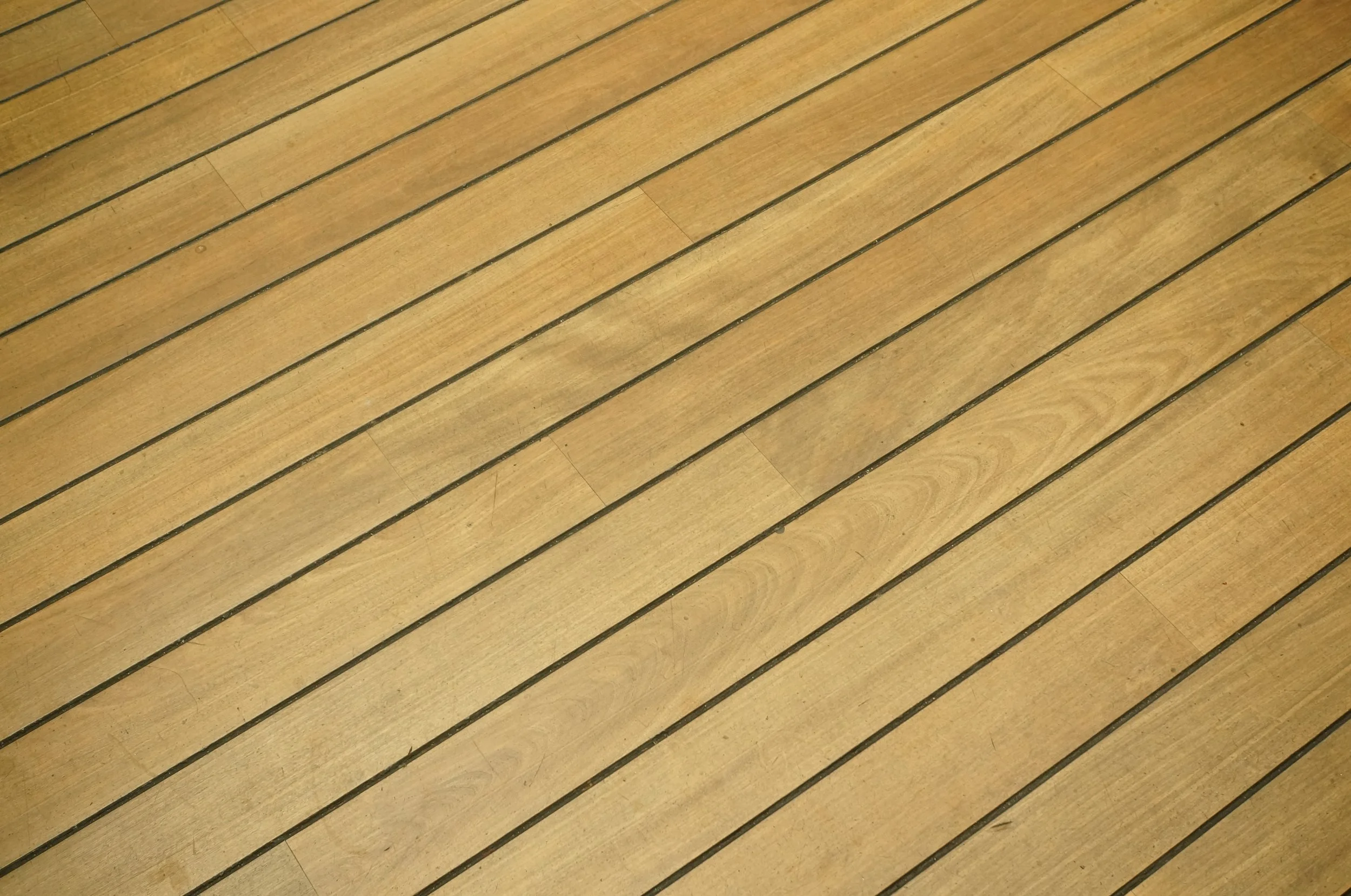Wooden deck with parallel planks stained.