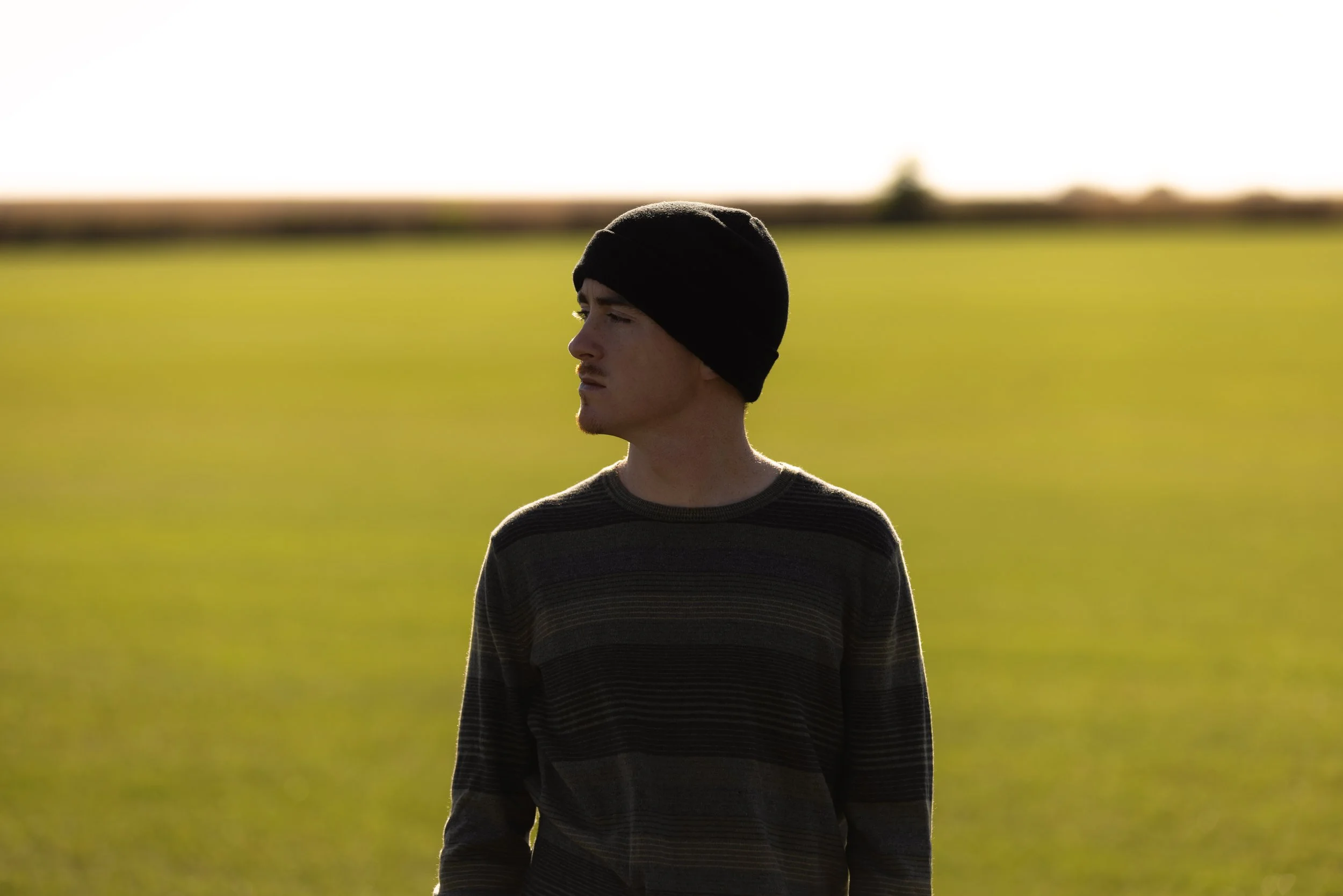 Tyler portrait in field.JPG