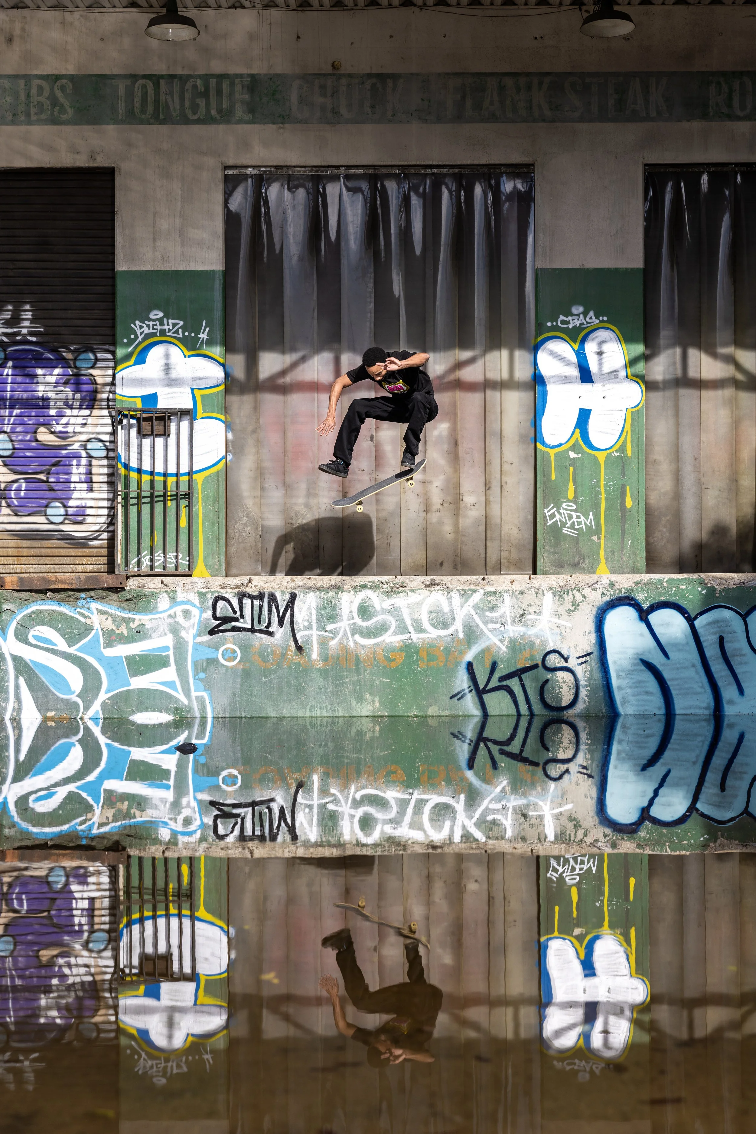 Timmy reflection kickflip on loading dock.jpg