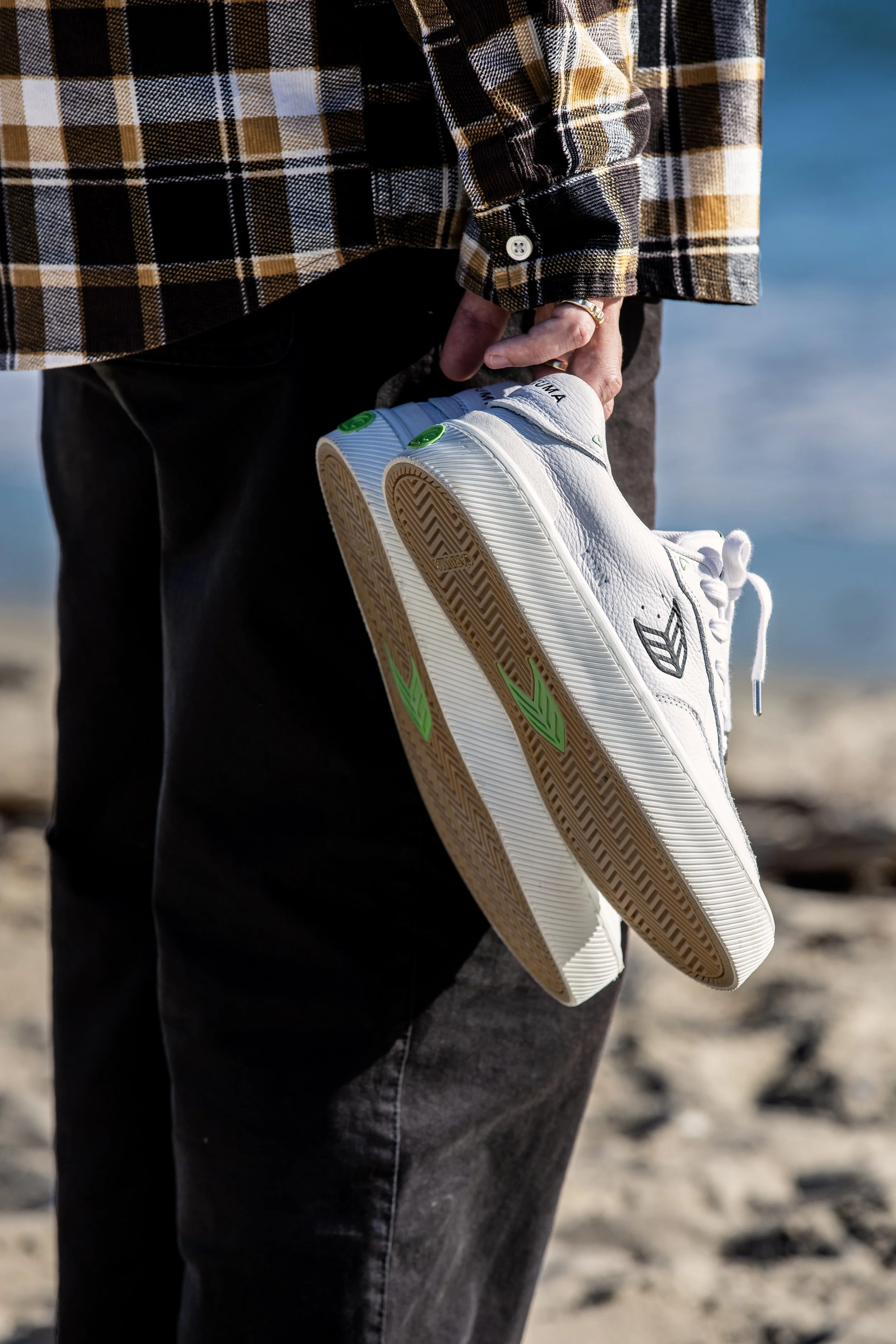 Luan holding white black shoes on beach close up (RE-EDIT).JPG