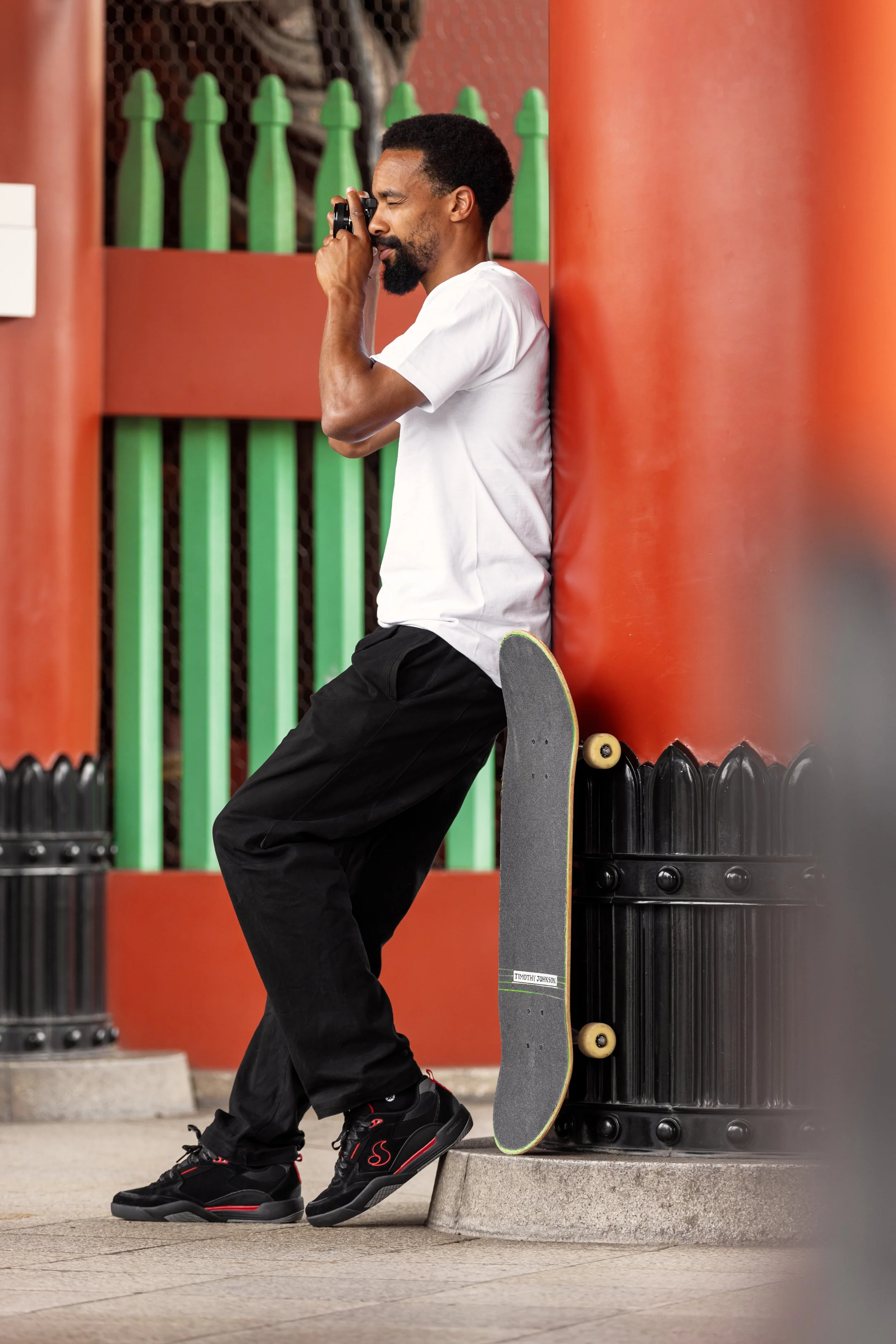 Timmy shooting photos at Senso-Ji Temple in black:red slots portrait (vertical).JPG