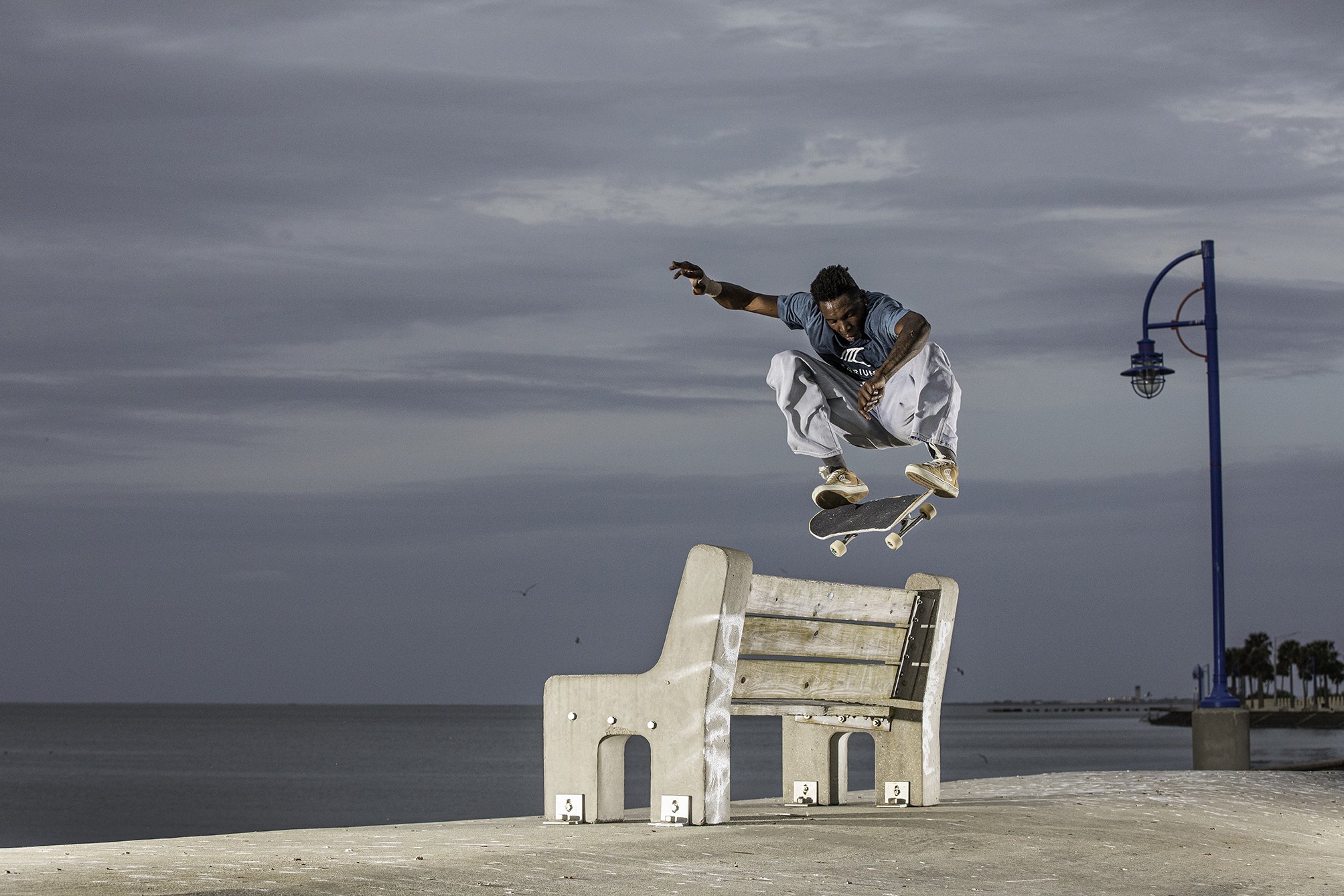 LeAndre kickflip over bench on water.jpg