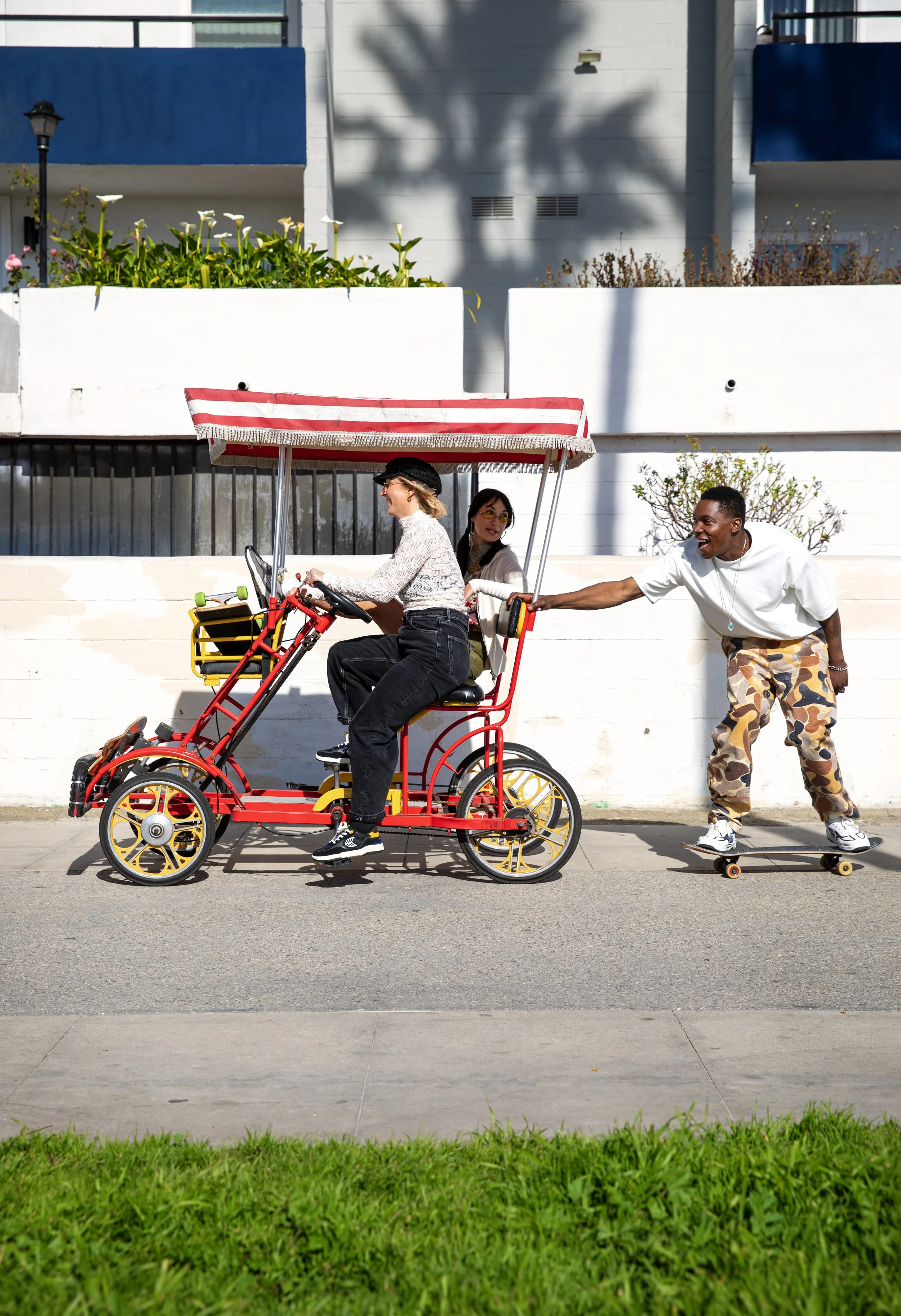 LeAndre holding on to back of bike on boardwalk.JPG