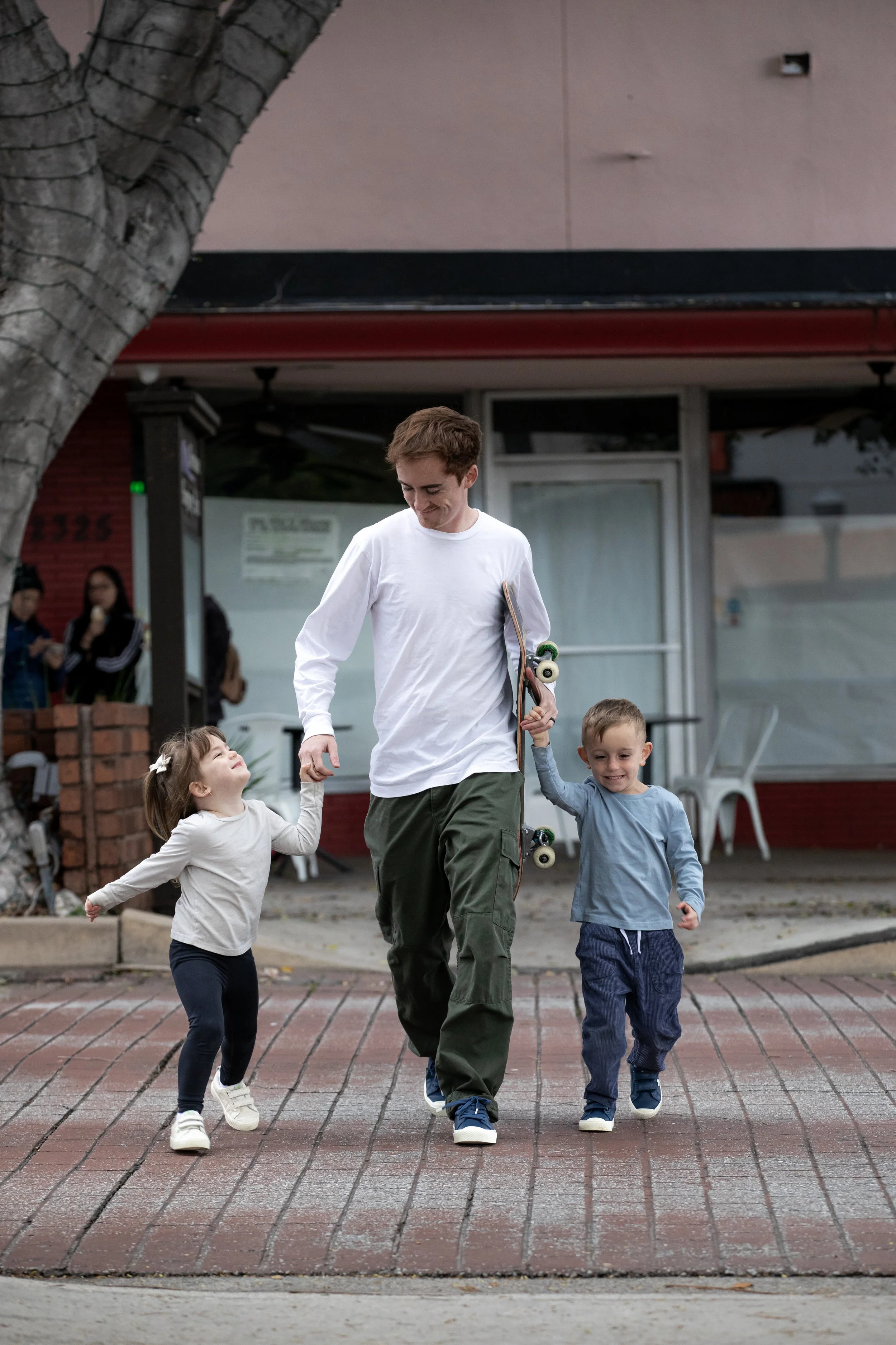 Tyler walking across crosswalk w Emy & Azai 1.JPG