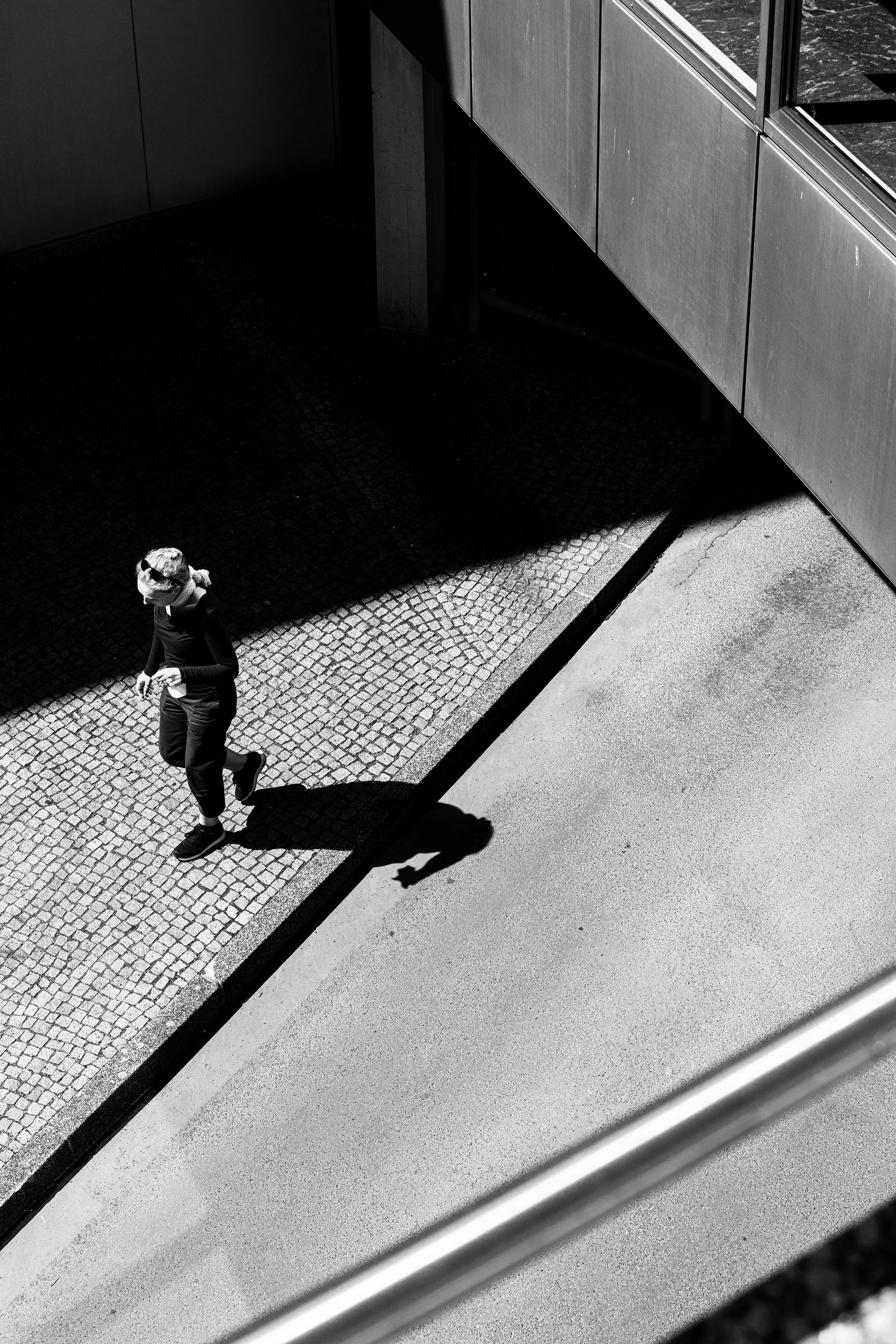 Pedestrian walking under bridge.jpg