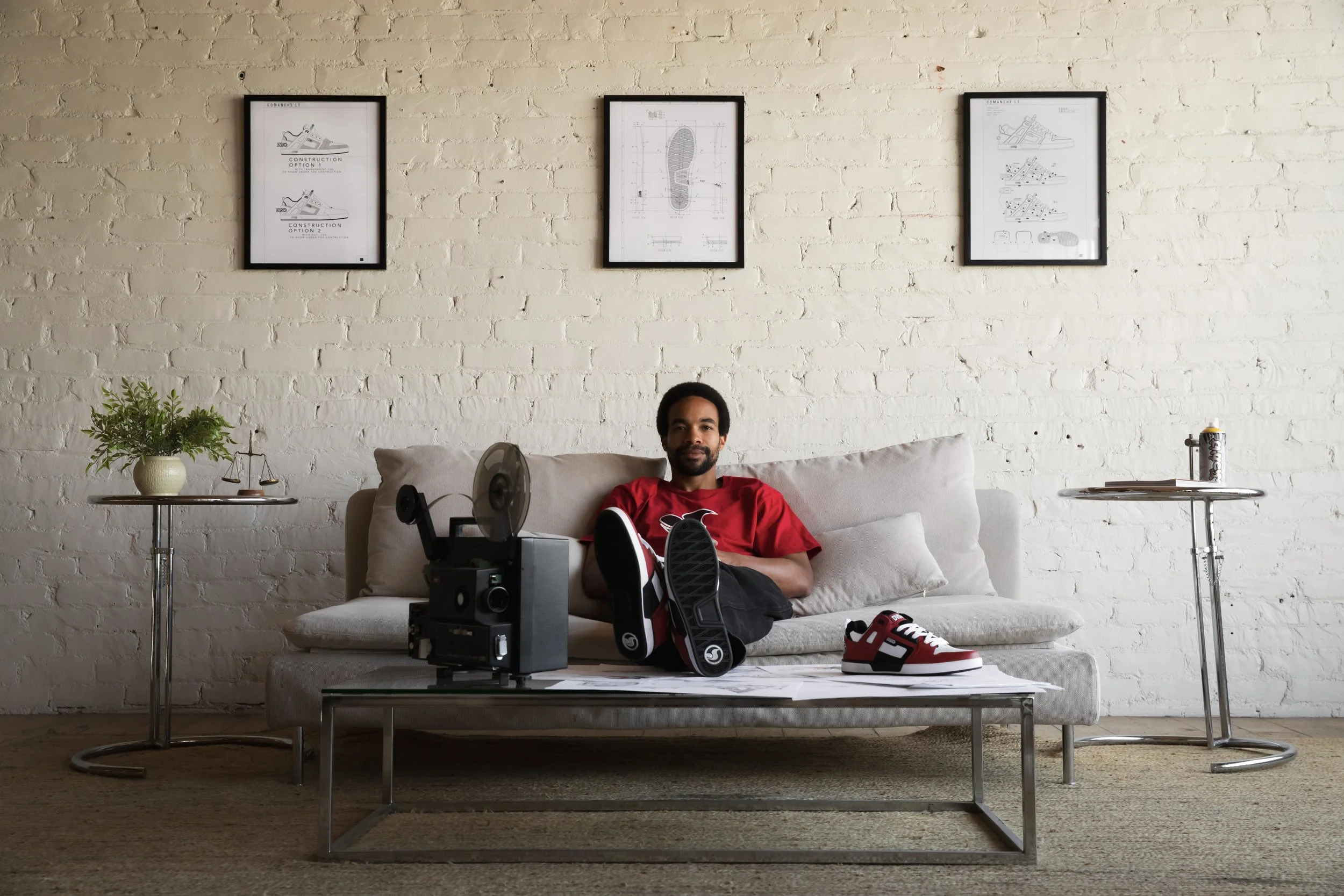 Timmy sitting on couch with red Comanche LT portrait.JPG