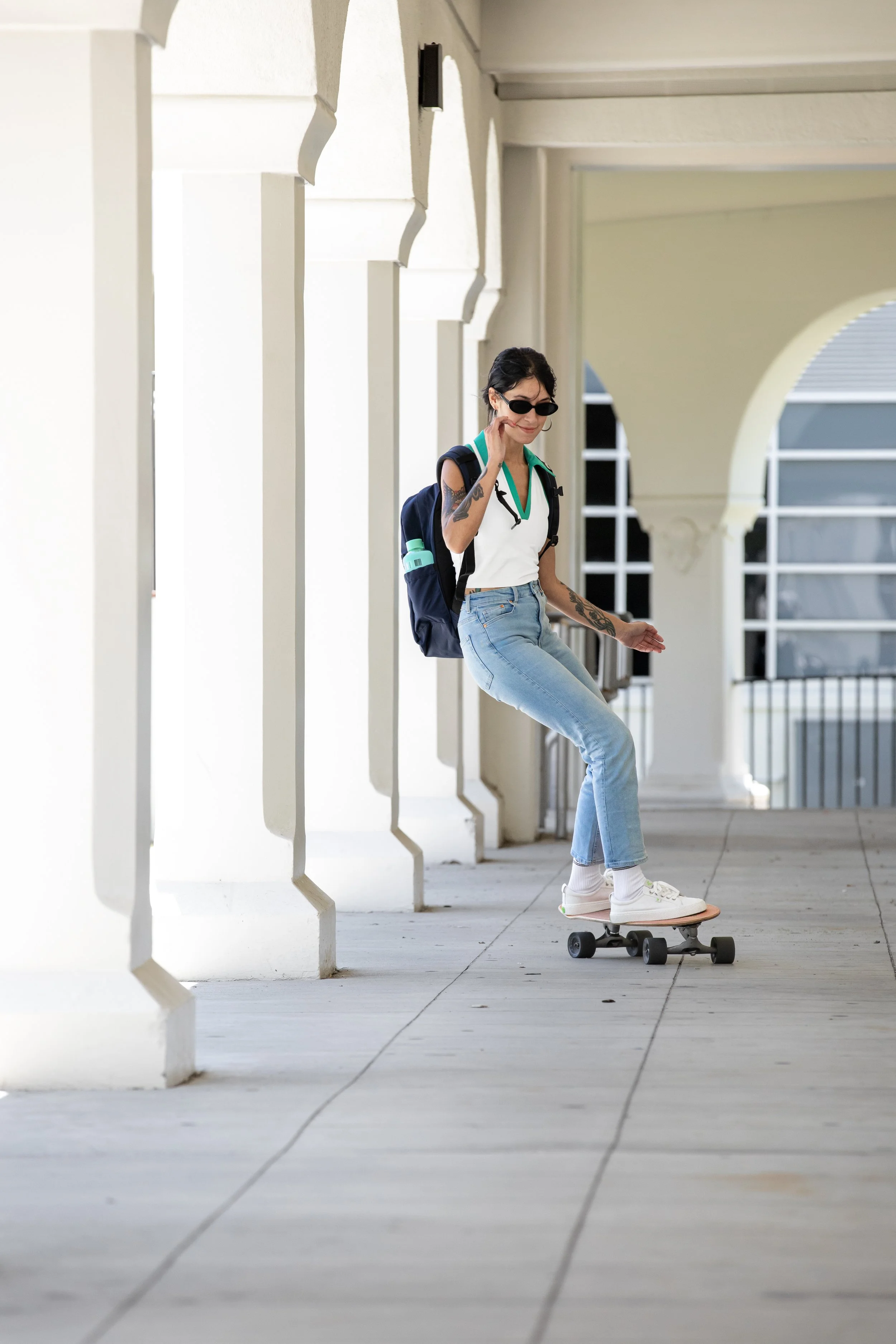 Myriah skating through hallway.JPG
