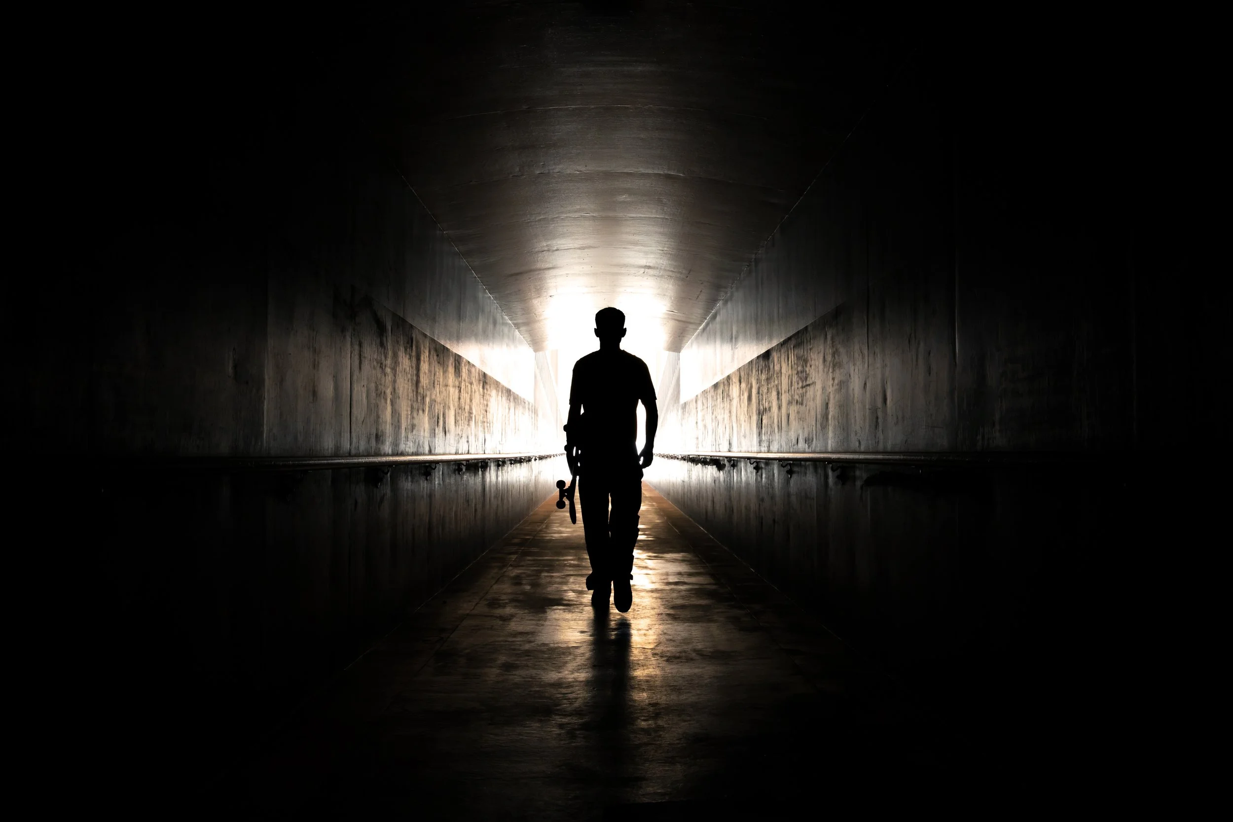 Tyler walking through train station tunnel silhouette portrait.JPG