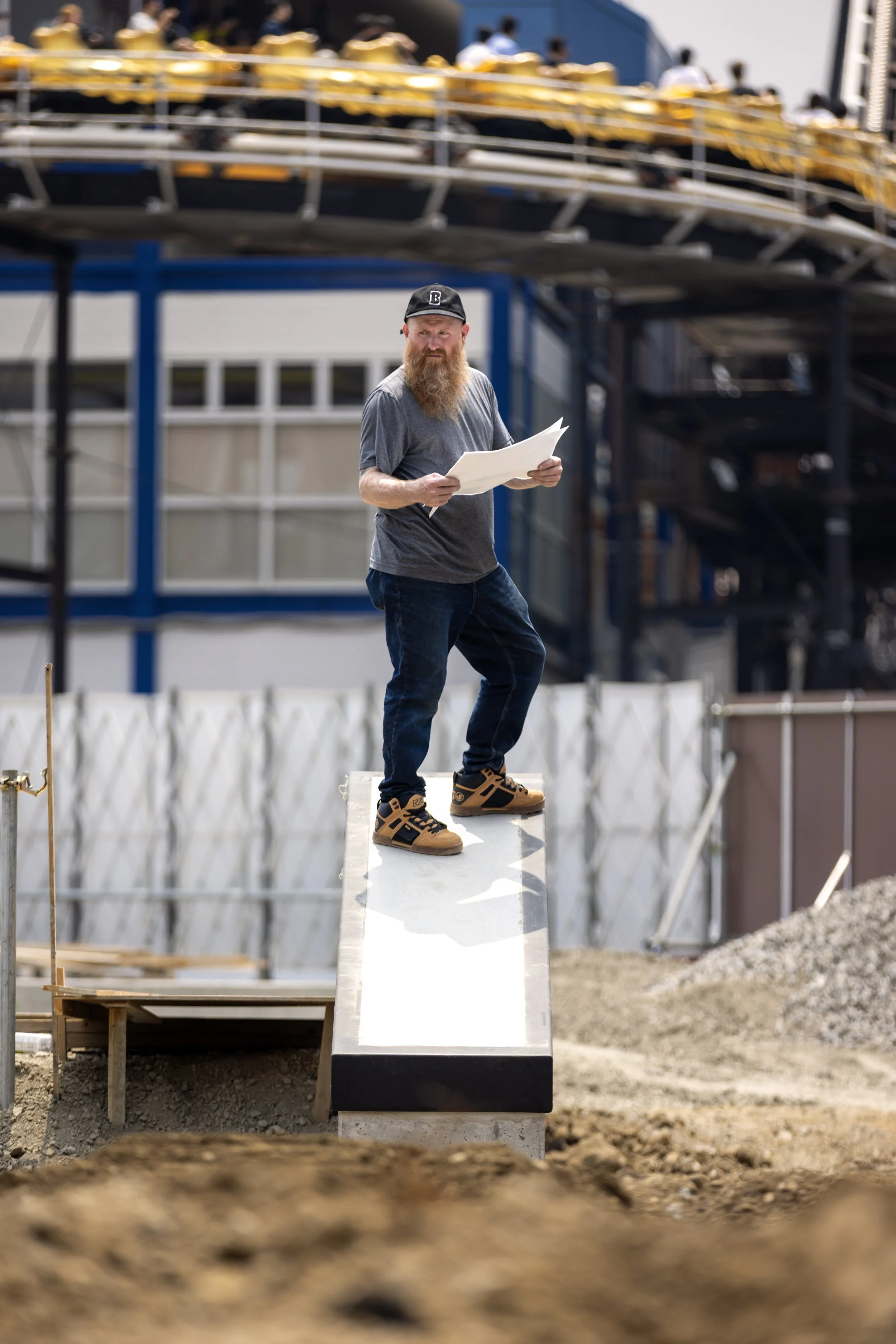 Brent looking at skatepark blueprints in park portrait 1.JPG